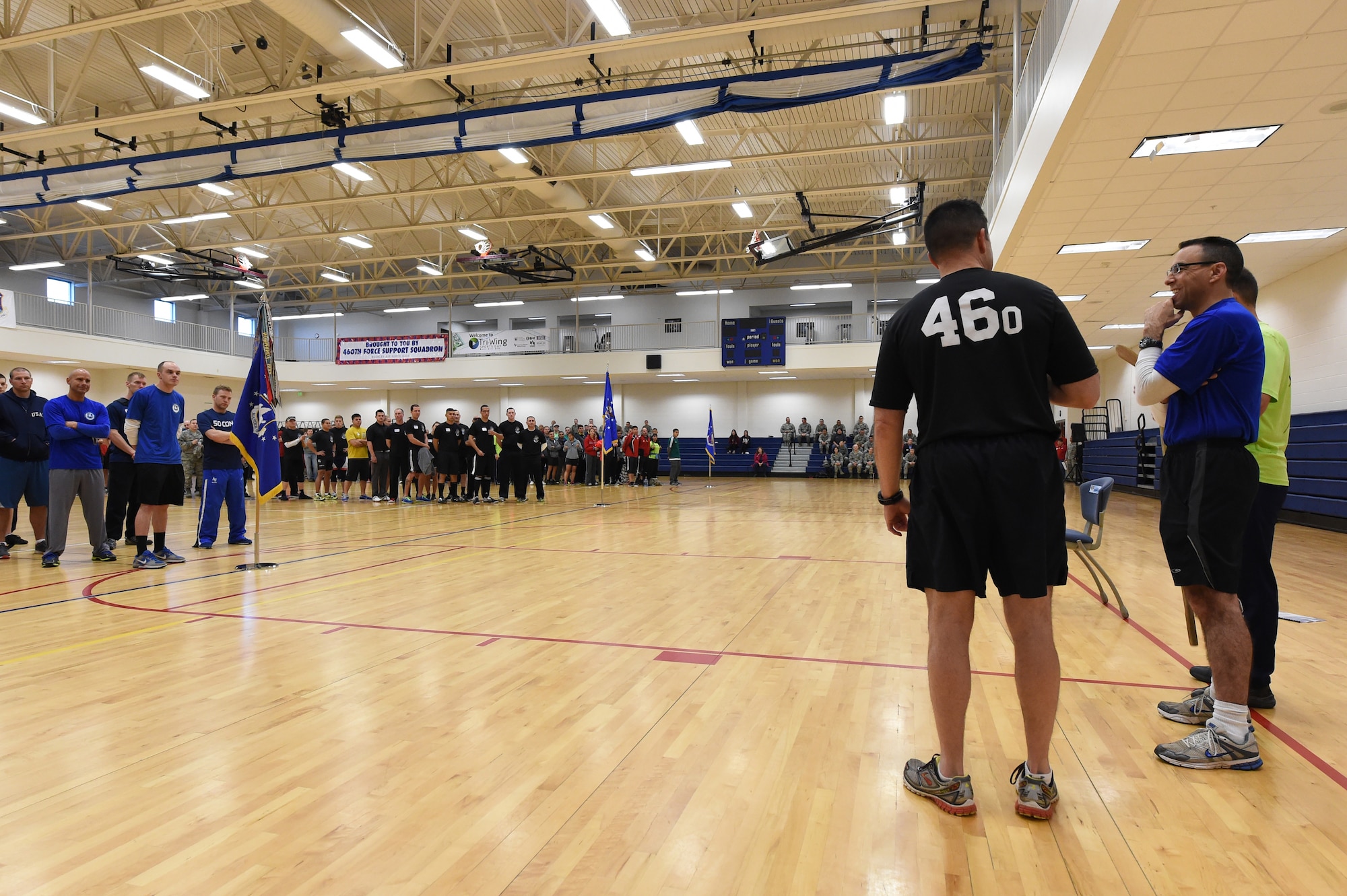 Col. John Wagner, 460th Space Wing commander, left; Col. Bill Liquori, 50th Space Wing commander, center; and Col. John Shaw, 21st Space Wing commander, right; address the crowd before the Tri-Wing Sports Day competition May 20, 2015, on Buckley Air Force Base, Colo. Tri-Wing Sports Day is held once a year between the three Air Force Space Command bases and is intended to promote healthy, active lifestyles and friendly competition. The bases competed against each other in over 15 sports such as volleyball, football, tennis and softball among others. (U.S. Air Force photo by Airman 1st Class Emily E. Amyotte/Released)