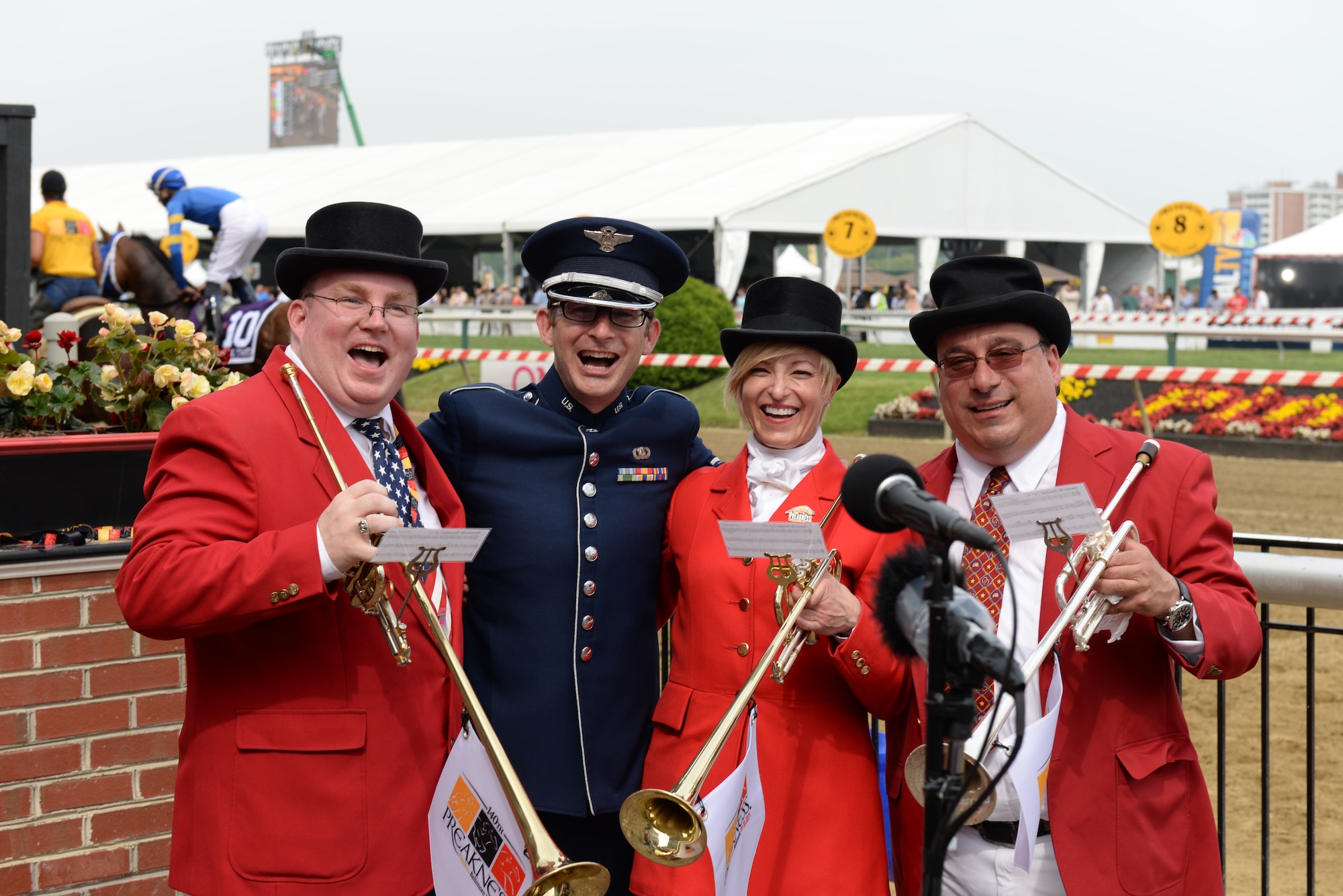 Senior Airman Mark Oates, trumpet player for the Heritage of America Band, poses with the Preakness Stakes Buglers after their shared performance of the traditional "Call of the Post" and "America the Beautiful" at the Pimlico race course May 16, 2015 in Baltimore, Maryland. Oates is a member of the newest ensemble of the Heritage of America Band, Full Spectrum. The event, which was nationally televised, broke records in attendance by hosting more than 170,000 people. (U.S. Air Force photo by Tech. Sgt. Steve Stanley/Released)