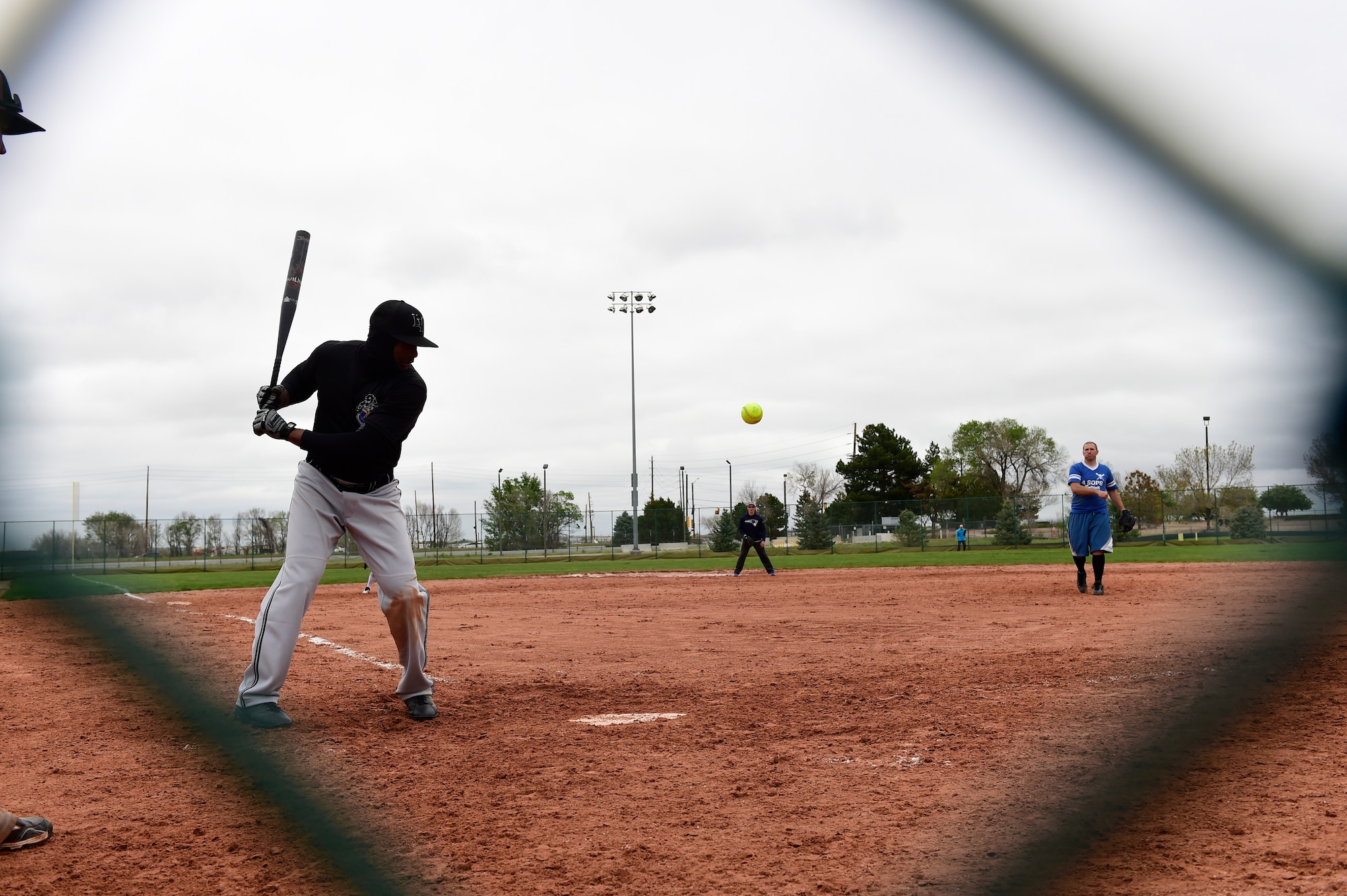 A softball player waits to hit the ball during the Tri-Wing Sports Day competition May 20, 2015, on Buckley Air Force Base, Colo. Tri-Wing Sports Day is held once a year between the three bases and is intended to promote healthy, active lifestyles and friendly competition. The bases competed against each other in over 15 sports such as volleyball, football, tennis and softball among others. (U.S. Air Force photo by Staff Sgt. Stephany Richards/Released)