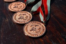 Medals are placed on a table to be handed out to winners of the 400 meter relay in the Special Olympics D.C. Summer Games at The Catholic University of America in Washington D.C., May 20, 2015. Special Olympics D.C. has been part of the Special Olympics movement since its start in 1968. (U.S. Air Force photo/Michael Martin)