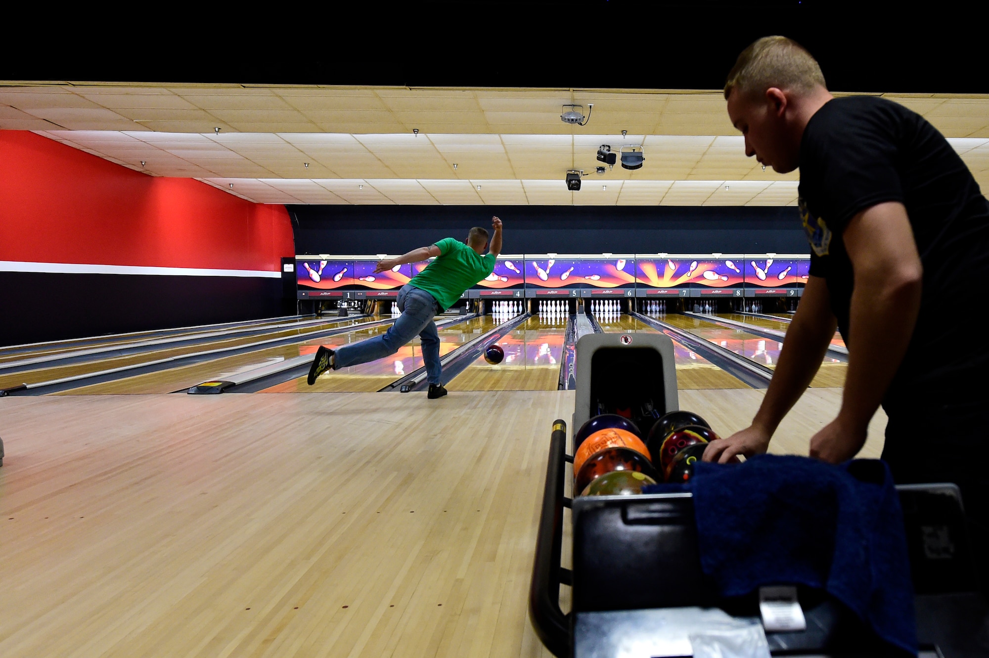 Bowlers compete against each other for 1st place during the Tri-Wing Sports Day competition May 20, 2015, on Buckley Air Force Base, Colo. Tri-Wing Sports Day is held once a year between the three Air Force Space Command bases and is intended to promote healthy, active lifestyles and friendly competition. The bases competed against each other in over 15 sports such as volleyball, football, tennis and softball among others. (U.S. Air Force photo by Staff Sgt. Stephany Richards/Released)