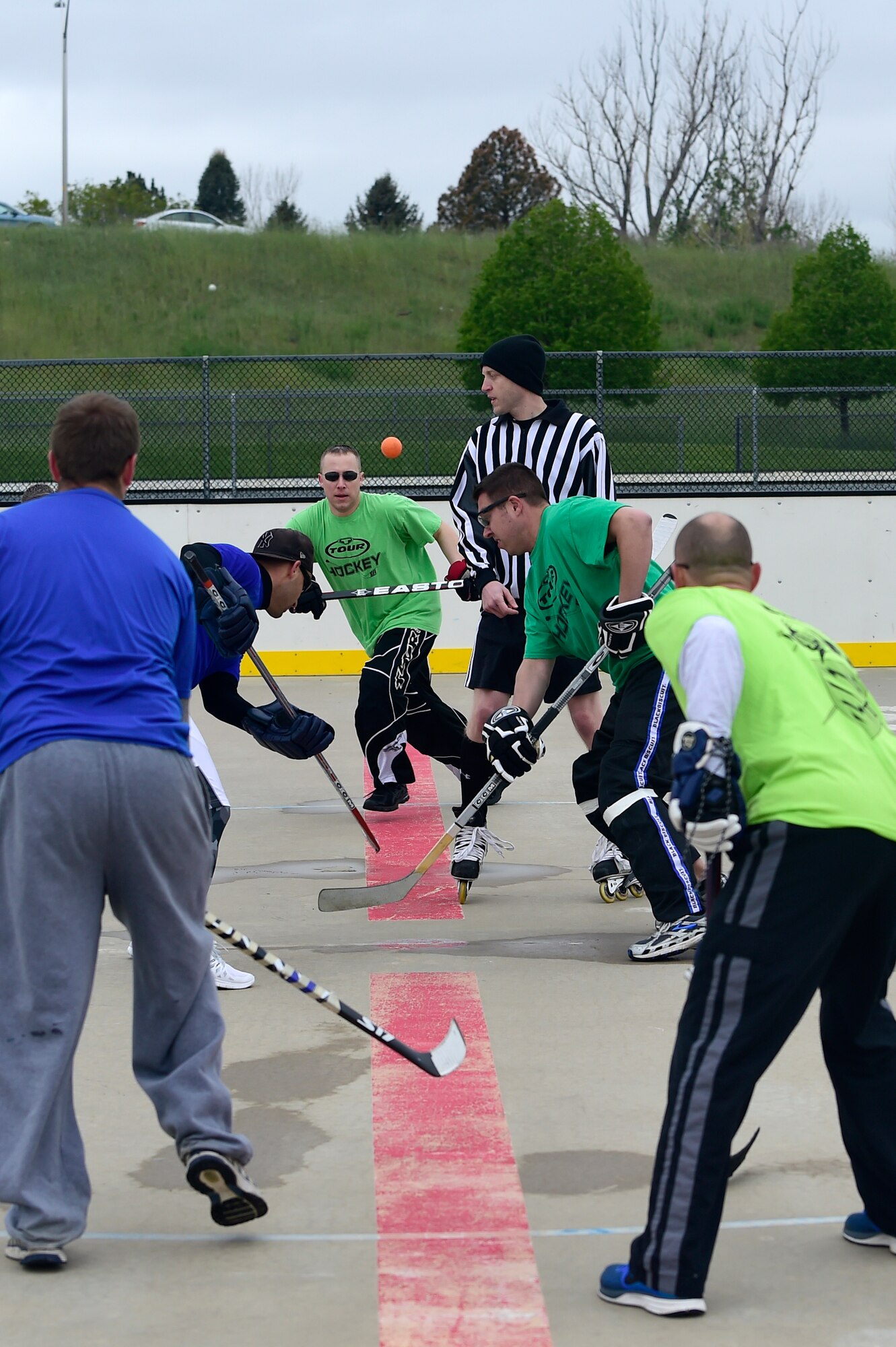 Peterson Air Force Base, Colo. and Shriever AFB, Colo., ball hockey players compete against each other for 1st place during the Tri-Wing Sports Day competition May 20, 2015, on Buckley AFB, Colo. Tri-Wing Sports Day is held once a year between the three Air Force Space Command bases and is intended to promote healthy, active lifestyles and friendly competition. The bases competed against each other in over 15 sports such as volleyball, football, tennis and softball among others. (U.S. Air Force photo by Staff Sgt. Stephany Richards/Released)