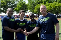 Air Force District of Washington Command Chief Master Sgt. Ferrell Thomas, athletes Gustavo Majano and Marlon Bryant, and Col Allan Swartzmiller, AFDW Mobilization Assistant to the Commander, prepare to compete in the Special Olympics D.C. Summer Games at The Catholic University of America in Washington D.C., May 20, 2015. The Air Force team raced against teams from the Army, Coast Guard, Marines, and Navy. (U.S. Air Force photo/Michael Martin)