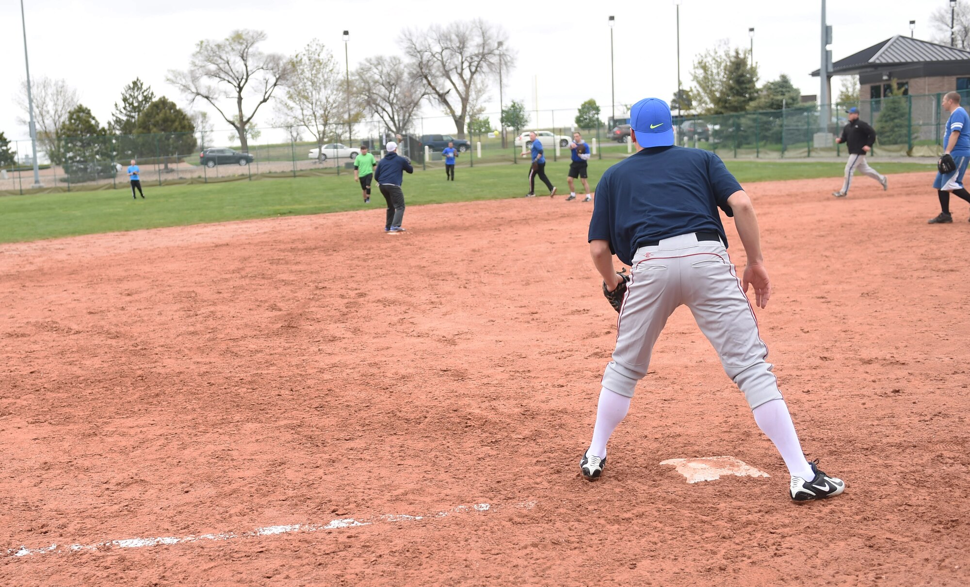 Softball players compete against each other for 1st place during the Tri-Wing Sports Day competition May 20, 2015, on Buckley Air force Base, Colo. Tri-Wing Sports Day is held once a year between the three Air Force Space Command bases and is intended to promote healthy, active lifestyles and friendly competition. The bases competed against each other in over 15 sports such as volleyball, football, tennis and softball among others. (U.S. Air Force photo by Airman 1st Class Samantha Meadors/Released)