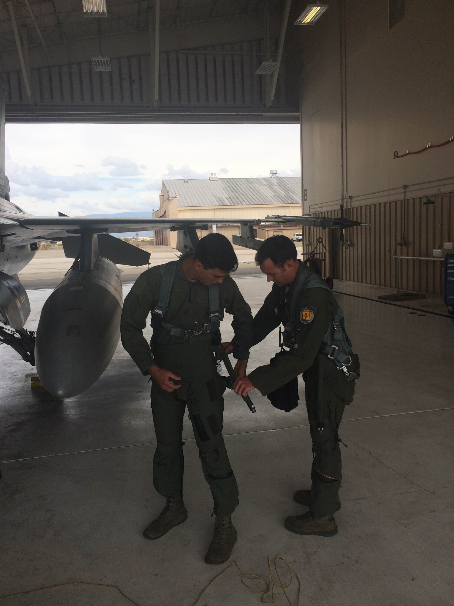 Senior Airman Aaron Feliciano, 49th Aircraft Maintenance Squadron Reaper aircraft maintenance unit avionics technician, gets his flight gear situated before his familiarization flight May 13, 2015 at Holloman Air Force Base, N.M. Although Airmen who receive a familiarization flight do not have to complete the rigorous demands of pilot training, they must complete a flight physical, training on aircrew flight equipment, and in-flight emergency and exit procedures. (Courtesy photo)