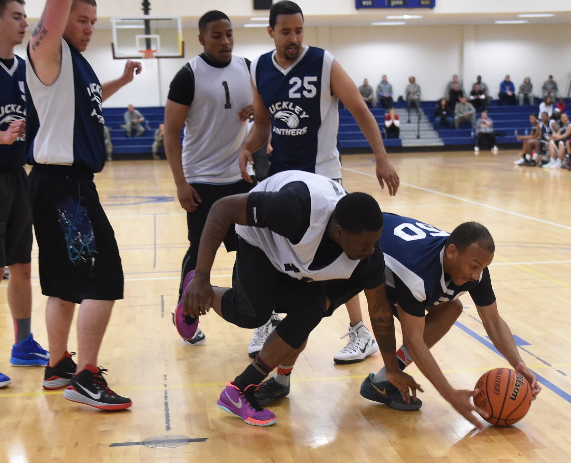 Basketball players compete against each other for 1st place during the Tri-Wing Sports Day competition May 20, 2015, on Buckley Air Force Base, Colo. Tri-Wing Sports Day is held once a year between the three Air Force Space Command bases and is intended to promote healthy, active lifestyles and friendly competition. The bases competed against each other in over 15 sports such as volleyball, football, tennis and softball among others. (U.S. Air Force photo by Airman 1st Class Samantha Meadors/Released)