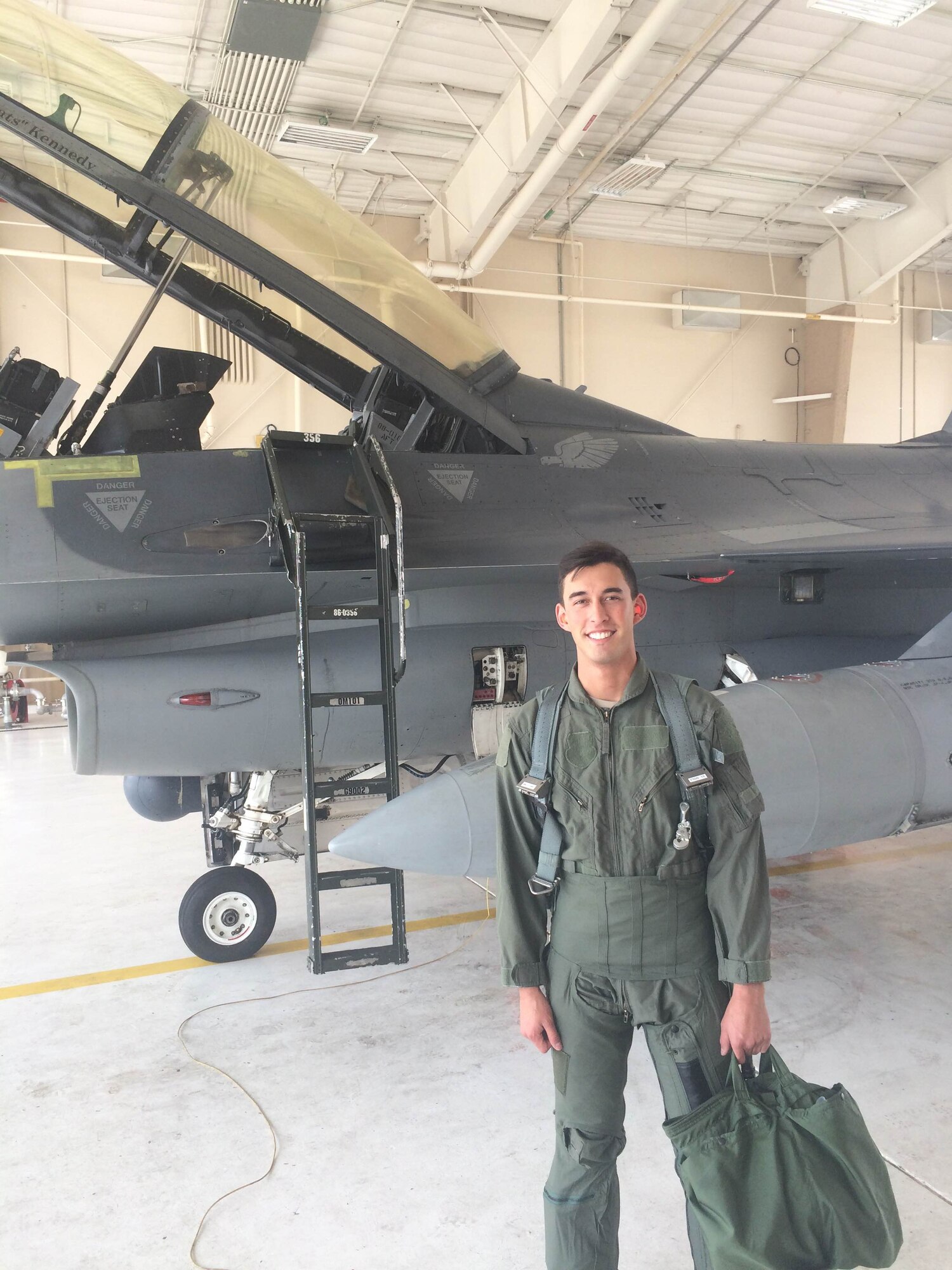 On Wednesday, May 13, 2015, Senior Airman Aaron Feliciano, 49th Aircraft Maintenance Squadron Reaper aircraft maintenance unit avionics technician, poses in front of an F-16 Fighting Falcon before his familiarization flight at Holloman Air Force Base, N.M. Feliciano, Air Combat Command’s Outstanding Airman of the Year, received his familiarization flight after a visit where he was recognized by ACC commander, Gen. Herbert “Hawk” Carlisle. (Courtesy photo)
