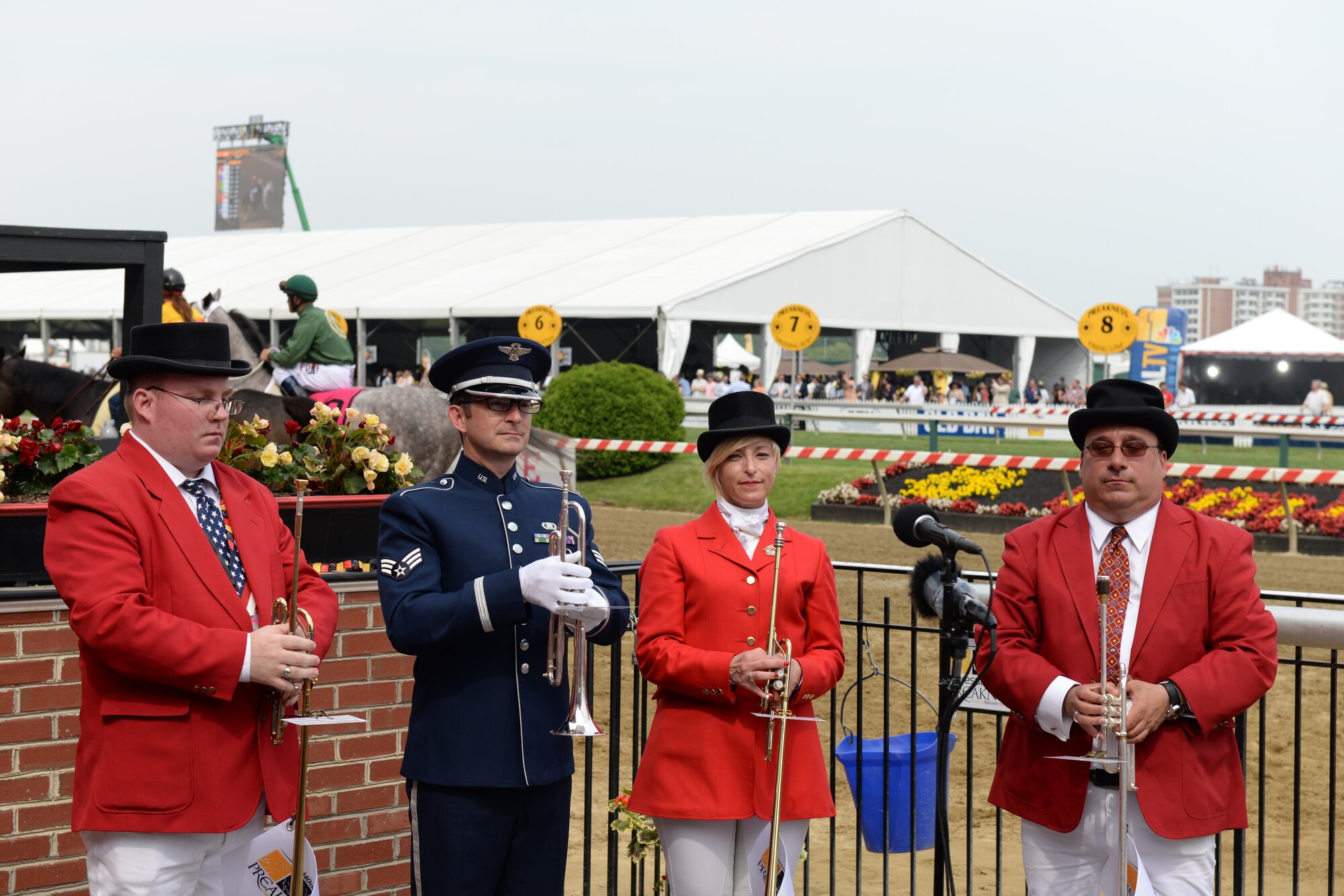 Senior Airman Mark Oates, trumpet player for the Heritage of America Band, performs the traditional "Call to the Post" and "America the Beautiful" with the Preakness Stakes Buglers at the Pimlico race course May 16, 2015 in Baltimore, Maryland. Oates is a member of the newest ensemble of the Heritage of America Band, Full Spectrum. The event, which was nationally televised, broke records in attendance by hosting more than 170,000 people. (U.S. Air Force photo by Tech. Sgt. Steve Stanley/Released)