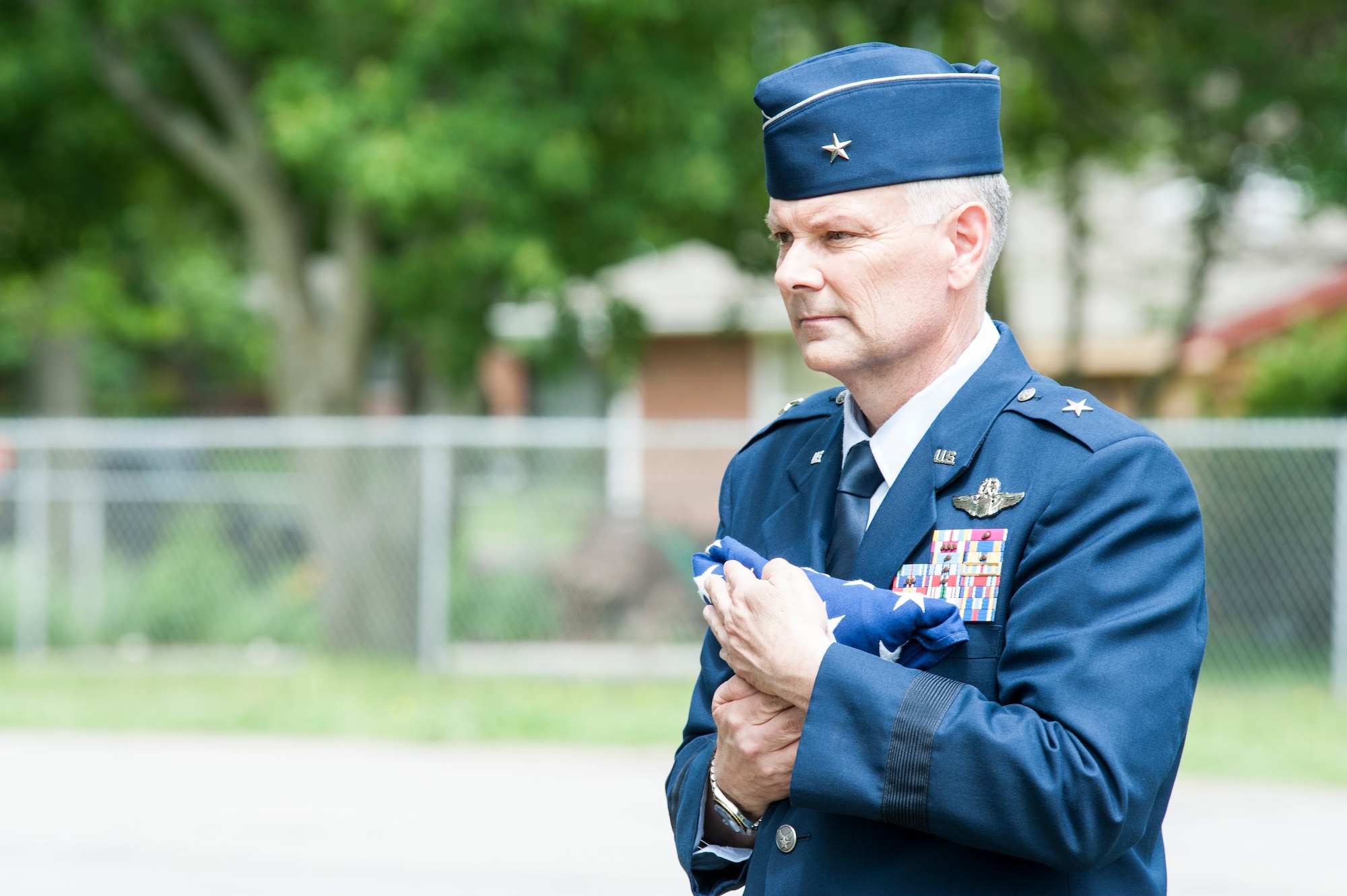 U.S. Air Force Brig. Gen. Glen VanHerck, right, 509th Bomb Wing commander, holds a flag honoring the sacrifice of 2nd Lt. George Whiteman May 16, 2015, during the annual wreath-laying ceremony in Sedalia, Mo. VanHerck’s first assignment as a young lieutenant was to the 44th Fighter Squadron, a descendant of the unit that Whiteman was assigned to when he died after his plane was shot down Dec. 7, 1941, during the attack on Pearl Harbor. (U.S. Air Force photo by Staff Sgt. Brigitte N. Brantley/Released)