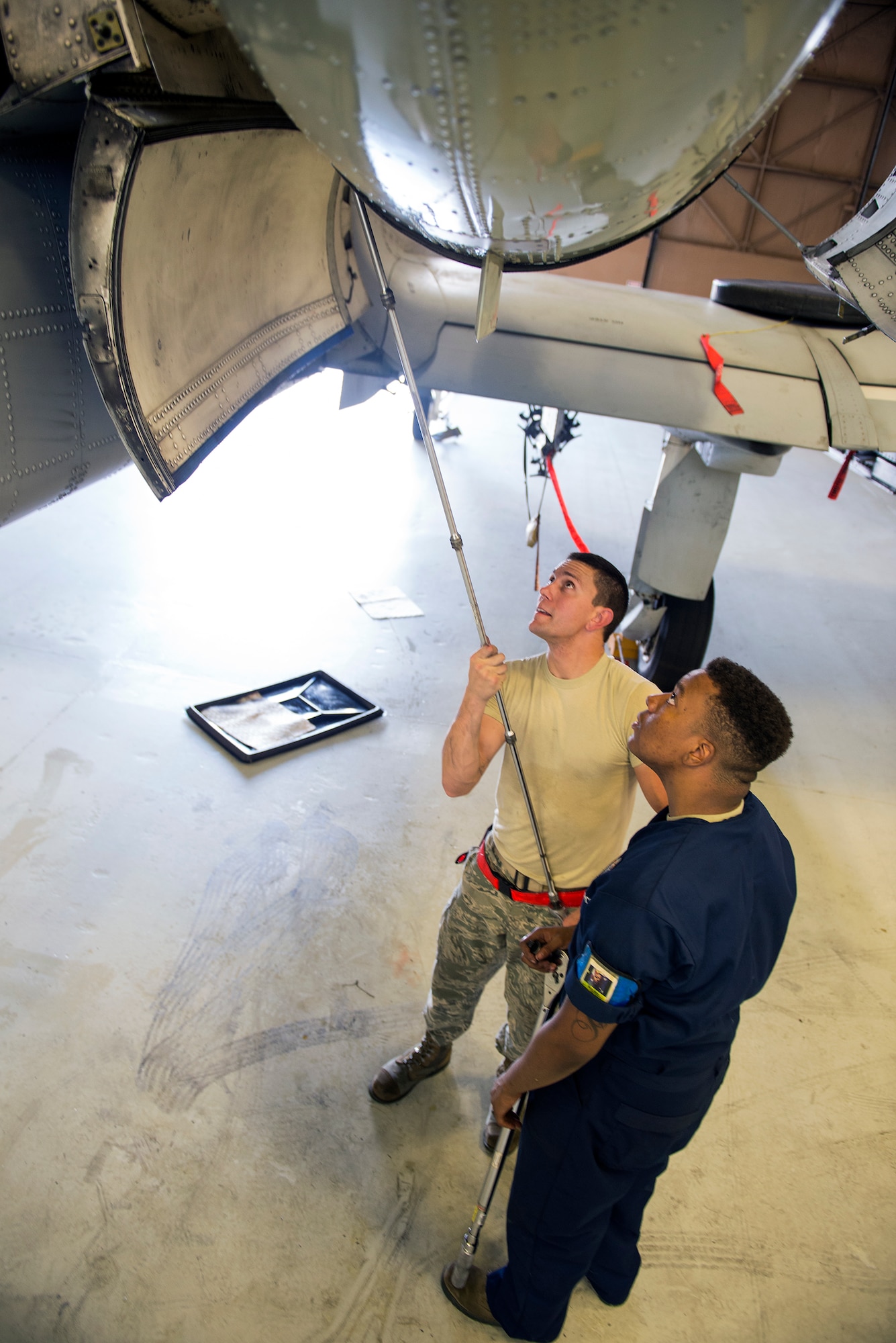 U.S. Air Force 75th Aircraft Maintenance Unit members Senior Airman Matthew Kupcho, crew chief, left, and Airman 1st Class Markes Woods, aerospace propulsion journeyman, take turns using “Big Bertha,” a 145-pound torque wrench, on one of four aft thrust mount bolts during an A-10C Thunderbolt II engine change May 18, 2015, at Moody Air Force Base, Ga. The bolts have to be torqued to 2000 inch-pounds pressure to ensure the engine can stay in place during flight. (U.S. Air Force photo by Airman Greg Nash/Released)