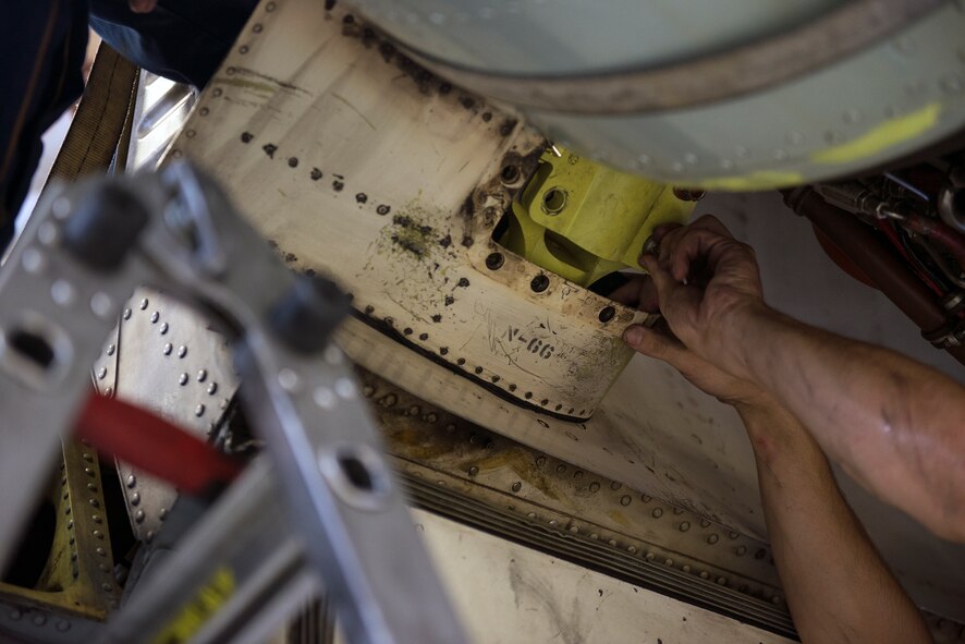 U.S. Air Force Senior Airman Matthew Kupcho, 75th Aircraft Maintenance Unit crew chief, tightens an aft thrust mount bolt during an A-10C Thunderbolt II engine change May 18, 2015, at Moody Air Force Base, Ga. Kupcho hand tightened bolts half-way, in preparation for the bolts to be torque wrench. (U.S. Air Force photo by Airman Greg Nash/Released) 