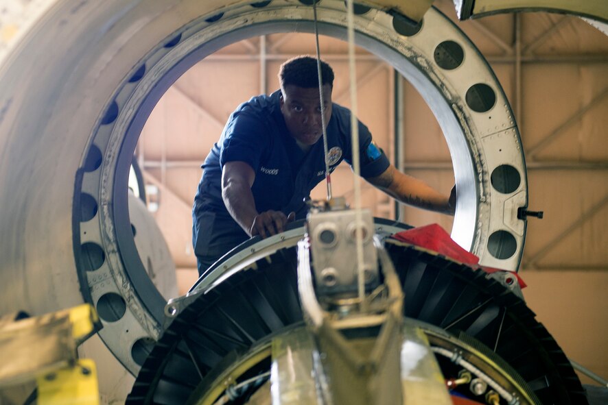 U.S. Air Force Airman 1st Class Markes Woods, 75th Aircraft Maintenance Unit aerospace propulsion journeyman, helps align an engine during an A-10C Thunderbolt II engine change May 18, 2015, at Moody Air Force Base, Ga. Woods is responsible for instructing the team on directing the engine to avoid hitting the aircraft. (U.S. Air Force photo by Airman Greg Nash/Released)