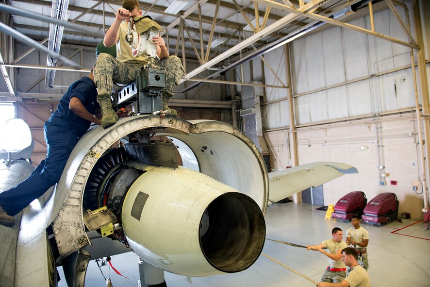 The 75th Aircraft Maintenance Unit and Air Force Engineering and Technical Service members participate in an A-10C Thunderbolt II engine change May 18, 2015, at Moody Air Force Base, Ga. The collective effort involved “top” and “bottom” teams comprised of three people each, which is required to complete the installation process. (U.S. Air Force photo by Airman Greg Nash/Released)