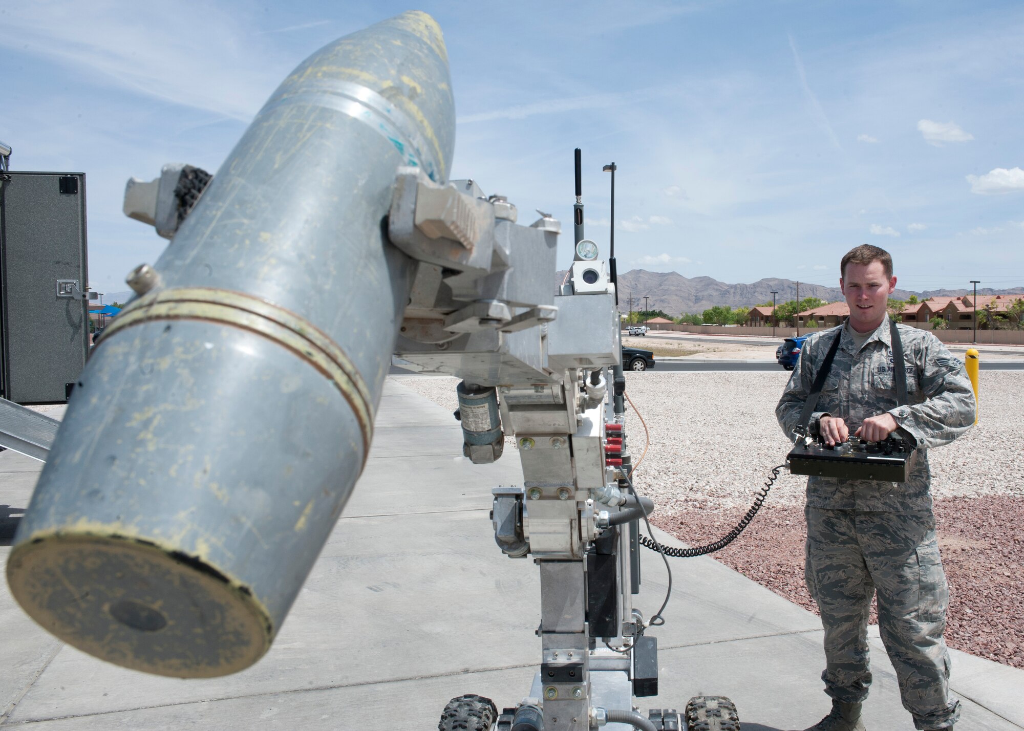 Senior Airman Wyland Wacaser, 99th Civil Engineer Squadron explosive ordnance disposal journeyman, operates the F6A robot by lifting up an inert unexploded ordnance on Nellis Air Force Base, Nev., May 13, 2015. While deployed, one of the EOD Airmen’s highest priorities may be counter IED, where they may encounter between 10 to 100 IED’s during their deployment. (U.S. Air Force photo by Airman 1st Class Jake Carter)