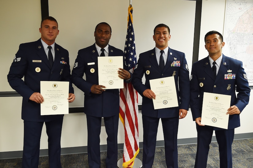 The Vice Presidential Service Badge is awarded to Staff Sgt. Peter Velez, former 811 Security Forces Squadron NCO in-charge of vice presidential aircraft security, Staff Sgt. Leonard Antonio, 811 SFS vice presidential aircraft security team leader, Staff Sgt. Sorhaindo Peter, 811 SFS vice presidential aircraft security team leader, Senior Airman Albert Ritterbeck, 811 SFS vice presidential aircraft security team members at Joint Base Andrews, Md., May 21, 2015. Only 473 people have been awarded the VPSB since its establishment in July, 1970. (U.S. Air Force photo/Senior Airman Joshua R. M. Dewberry)