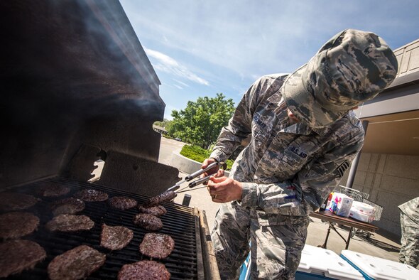 Airmen from the 366th Public Health Flight grilled burgers and hot dogs for visitors at the base exchange May 21, 2015 at Mountain Home Air Force Base, Idaho. Public Health hosted the event to educate Airmen and their families about proper food cooking and handling techniques. (U.S. Air Force Photo by Airman 1st Class Connor J. Marth/RELEASED)