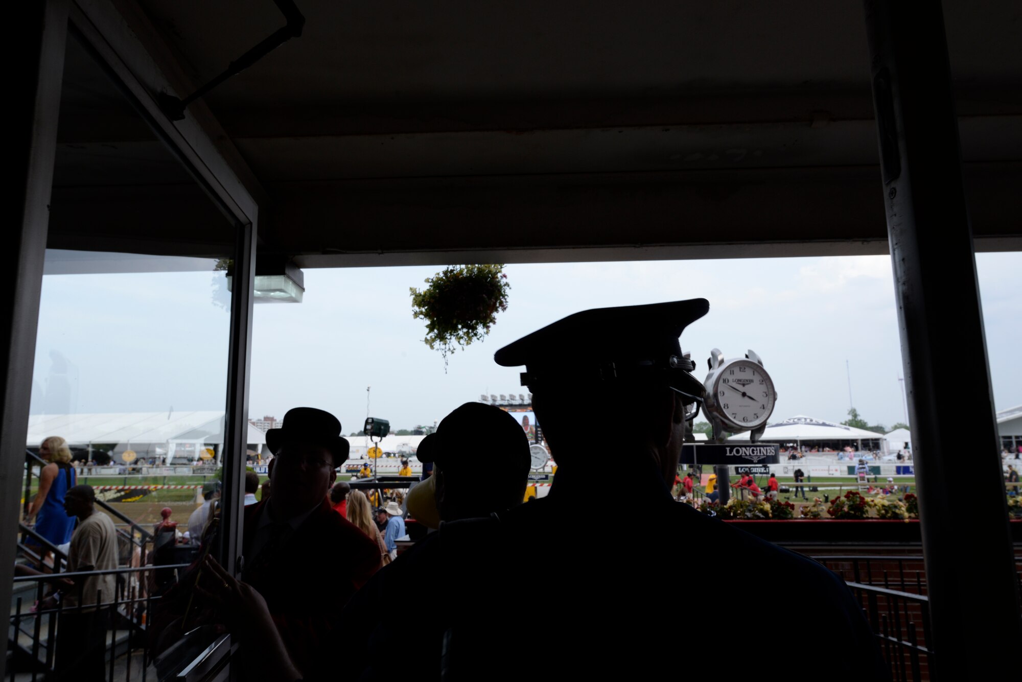 Senior Airman Mark Oates, trumpet player for the Heritage of America Band, steps out to the track in front of a record crowd at the Preakness Stakes May 16, 2015 in Baltimore, Maryland. Oates is a member of the newest ensemble of the Heritage of America Band, Full Spectrum. The event, which was nationally televised, broke records in attendance by hosting more than 170,000 people. (U.S. Air Force photo by Tech. Sgt. Steve Stanley/Released)