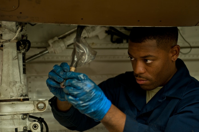 Senior Airman Michael Ford, 57th Aircraft Maintenance Squadron Viper Aircraft Maintenance Unit crew chief, inspects a landing gear component of an F-16 Fighting Falcon at Nellis Air Force Base, Nev., May 18, 2015. Crew chiefs are responsible for overseeing the day-to-day maintenance of aircraft, including diagnosing malfunctions and replacing components, and conducting various inspections to ensure the aircraft is functioning properly. (U.S. Air Force photo by Staff Sgt. Siuta B. Ika)