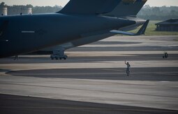 An Airman clears the side of a C-17 May 21, 2015, at Joint Base Charleston, S.C. during exercise Crescent Reach 2015. The exercise tested JB Charleston’s ability to launch a large aircraft formation and mobilize a large amount of cargo and passengers. (U.S. Air Force photo/Senior Airman Jared Trimarchi)