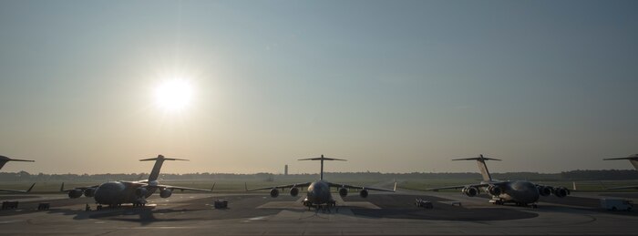 C-17 Globemaster IIIs sit in the sun before the beginning of multi-ship formation May 21, 2015, at Joint Base Charleston, S.C. during exercise Crescent Reach 2015. The exercise tested JB Charleston’s ability to launch a large aircraft formation and mobilize a large amount of cargo and passengers. (U.S. Air Force photo/Senior Airman Jared Trimarchi)