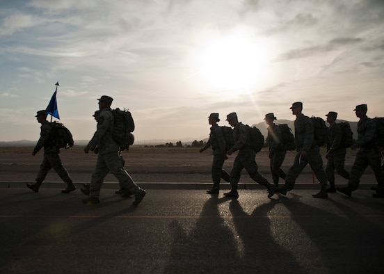 Airmen assigned to the 99th Security Forces Squadron participate in a 10K memorial ruck march for National Police Week at Nellis Air Force Base, Nev., May 13, 2015. The march was one of many events held at Nellis AFB to honor the sacrifices of both military and civilian law enforcement members. (U.S. Air Force photo by Staff Sgt. Siuta B. Ika)