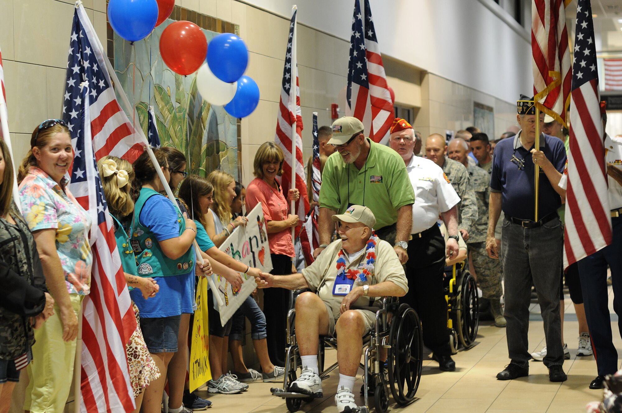 A picture of U.S. Air Force Airmen people from the community lining the halls of Clearwater International Airport, Fla. to welcome home veterans of World War II.