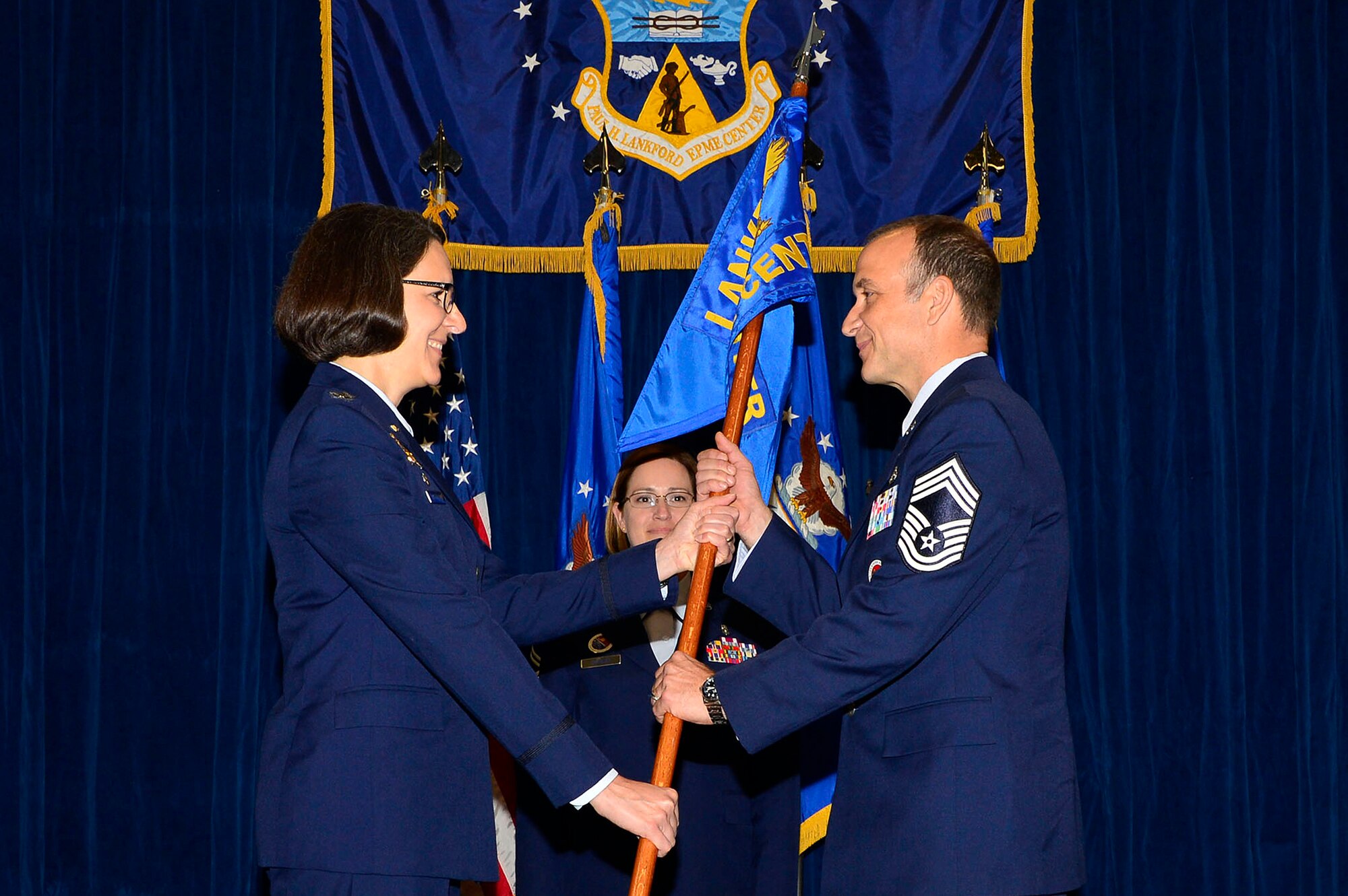 MCGHEE TYSON AIR NATIONAL GUARD BASE, Tenn. - Col. Jessica Meyeraan, commander, hands the guidon to the 14th Commandant of the Paul H. Lankford Enlisted PME Center, I.G. Brown Training and Education Center, Chief Master Sgt. Edward L. Walden, Sr. in Wilson Hall here May 20, 2015, during an assumption ceremony. (U.S. Air National Guard photo by Master Sgt. Jerry Harlan/Released)