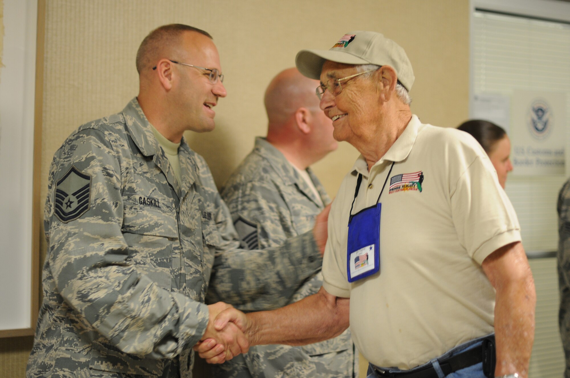 A picture of U.S. Air Force Airmen welcome home veterans of World War II.