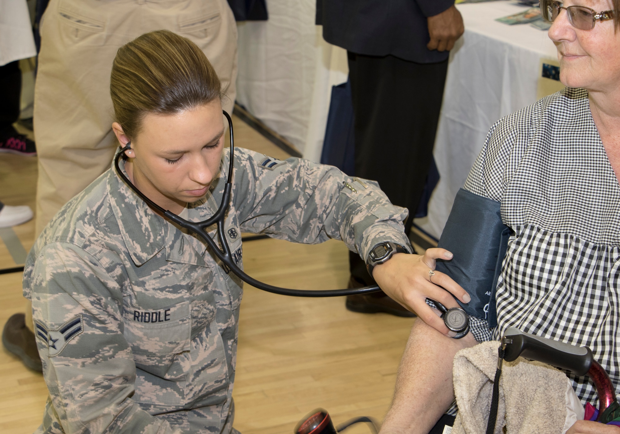 Airman 1st Class Patricia Riddle, 412th Medical Group medical technician, checks a retiree's blood pressure during Edwards Air Force Base Military Retiree Appreciation Day May 16, 2015, at the Rosburg Fitness Center. Approximately 27 information and services booths were set up throughout the fitness center basketball court with breakout sessions that occurred throughout the morning. (U.S. Air Force photo by Brad White)