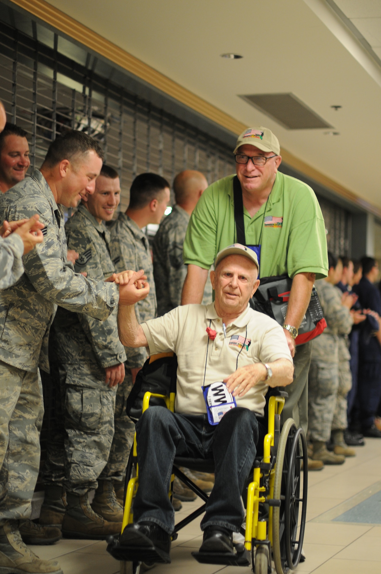 A picture of U.S. Air Force Airmen welcoming home veterans of World War II.