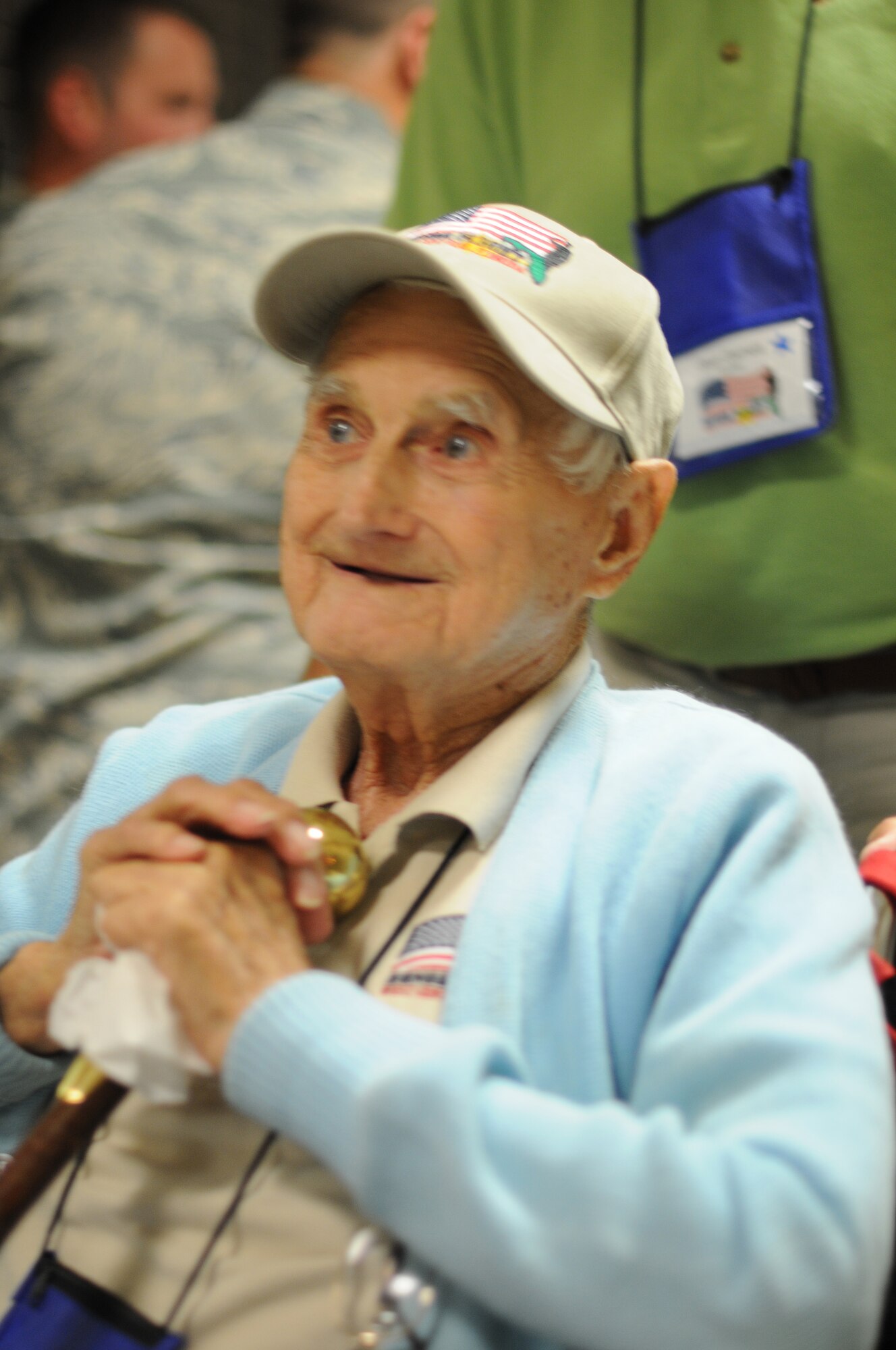 A picture of a World War II veteran in a wheelchair being pushed through Clearwater International Airport.