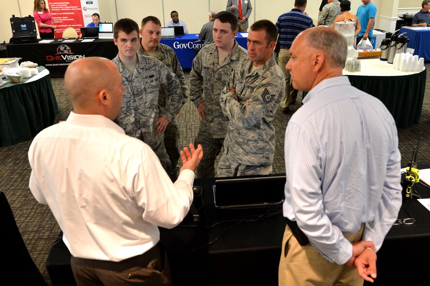 U.S. Air Force Airmen assigned to the 20th Fighter Wing discuss products with vendors the technology expo at the Carolina Skies Club and Conference Center at Shaw Air Force Base, S.C., May 20, 2015. The 20th Communications Squadron hosted the expo put on by National Conference Services Incorporated, to show members of Team Shaw the newest technological. (U.S. Air Force photo by Airman 1st Class Michael Cossaboom/Released)
