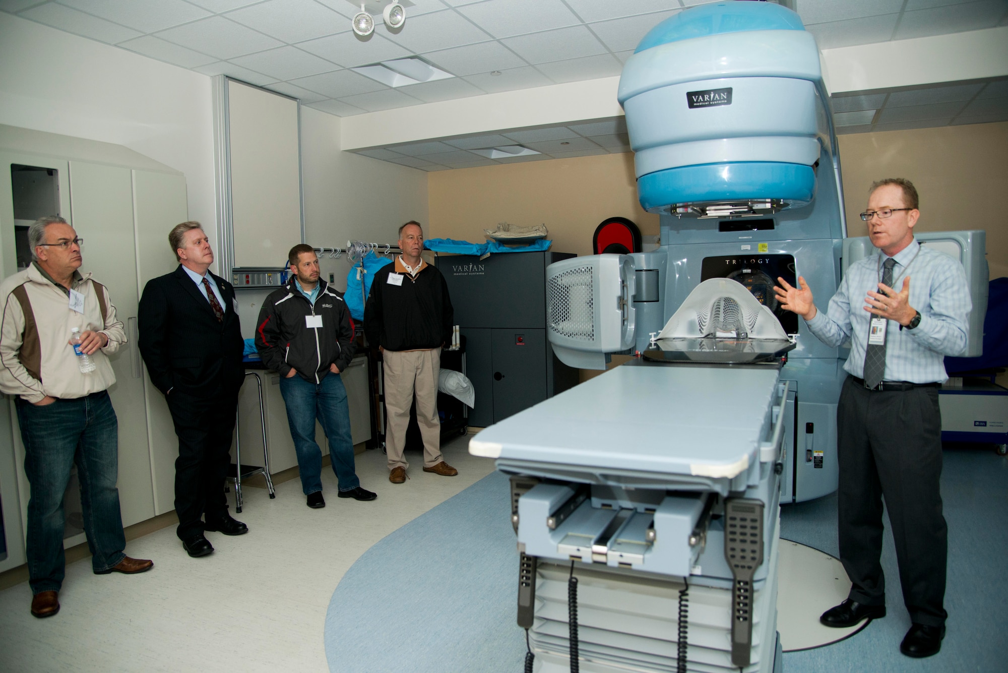 Harry Armstrong, 60th Medical Group joint radiation oncology center, explains to Honorary Commander's about the RapidArc, the most advanced and efficient method for delivering cancer-fighting treatment, which enables delivery of a few high doses of radiation with extreme precision, during the honorary commander tour May 15 at David Grant USAF Medical Center at Travis Air Force Base, Calif. (U.S. Air Force photo by Senior Airman Nicole Leidholm)