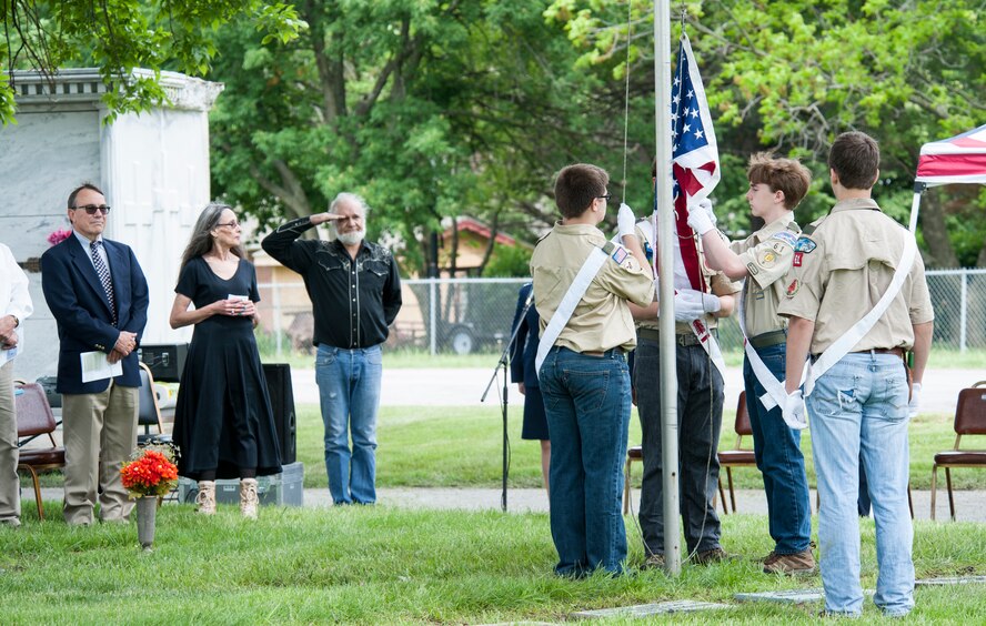 Community members watch as local Boy Scouts raise a flag May 16, 2015, during the annual wreath-laying ceremony in Sedalia, Mo., honoring the ultimate sacrifice of 2nd Lt. George Whiteman. Whiteman, a Sedalia native, was in the Air Force for less than two years when he became one of the first Airmen to die during World War II.  (U.S. Air Force photo by Staff Sgt. Brigitte N. Brantley/Released)