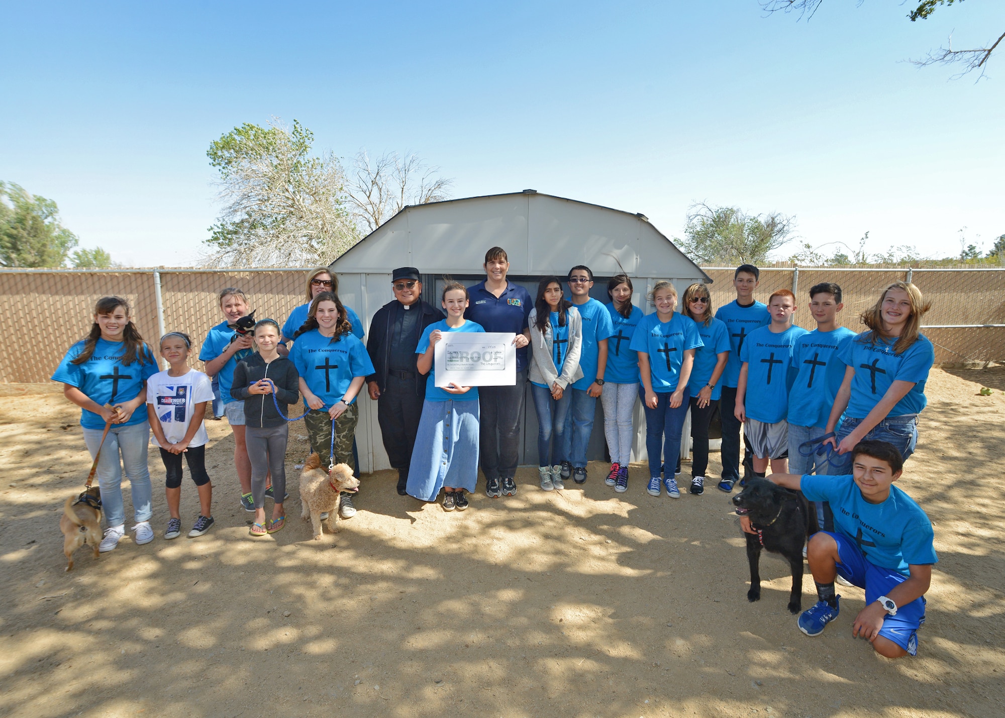 A youth group from the Base Chapel's Catholic parish, called The Conquerors, took time to raise funds and donate money to the base’s local Adopt-A-Pet (APET) shelter May 18. APET is a non-profit, no-kill animal rescue shelter for dogs and cats located on Edwards Air Force Base, Calif. (U.S. Air Force photo by Jet Fabara)