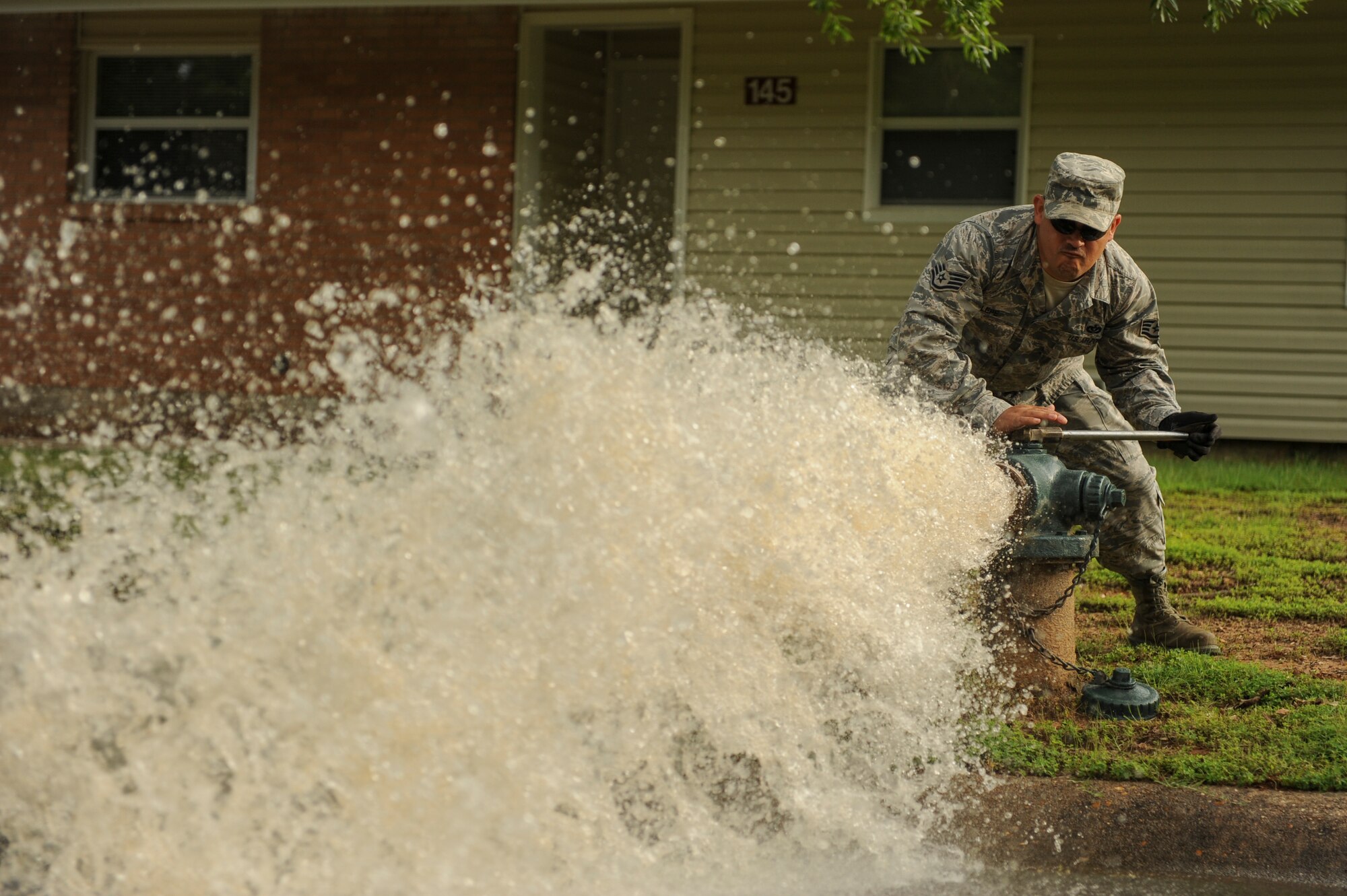 Staff Sgt. Luis Lepe, 19th Civil Engineer Squadron water and fuel system craftsman, flushes a fire hydrant May 12, 2015, at Little Rock Air Force Base, Ark. Hydrants are flushed annually to ensure they maintain proper pressure and are operational to fight fires. (U.S. Air Force photo by Senior Airman Scott Poe)