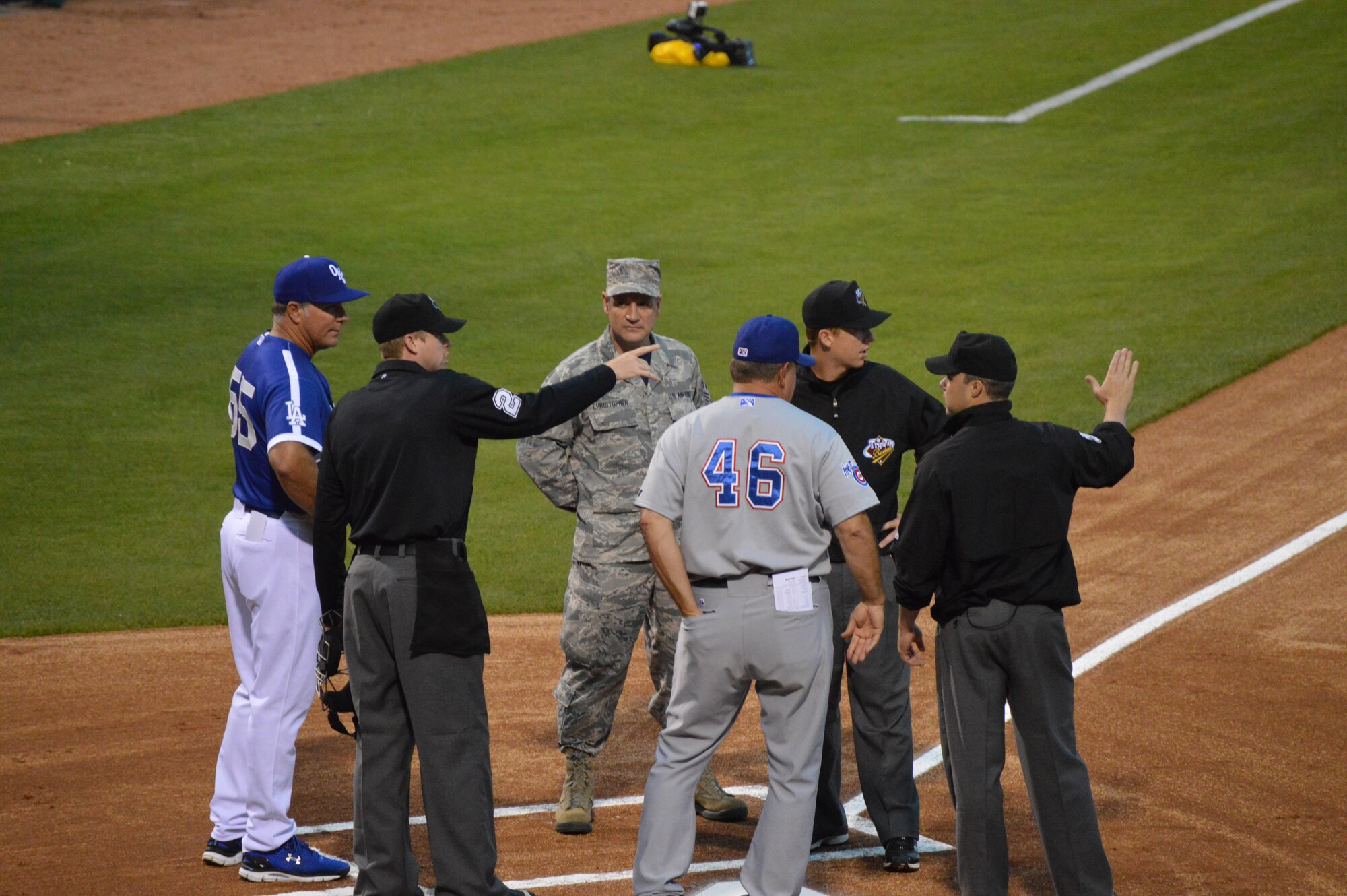 After delivering the starting lineup to home base, 72nd Air Base Wing Command Chief Master Sgt. Thomas Christopher listens as umpires Kolin Kline, Nate White and Nick Mahriey, from left, go over the ground rules with Oklahoma City Dodgers Manager Damon Berryhill, far left, and Iowa Cubs Manager Marty Pevey.  (Air Force photo by April McDonald/Released)