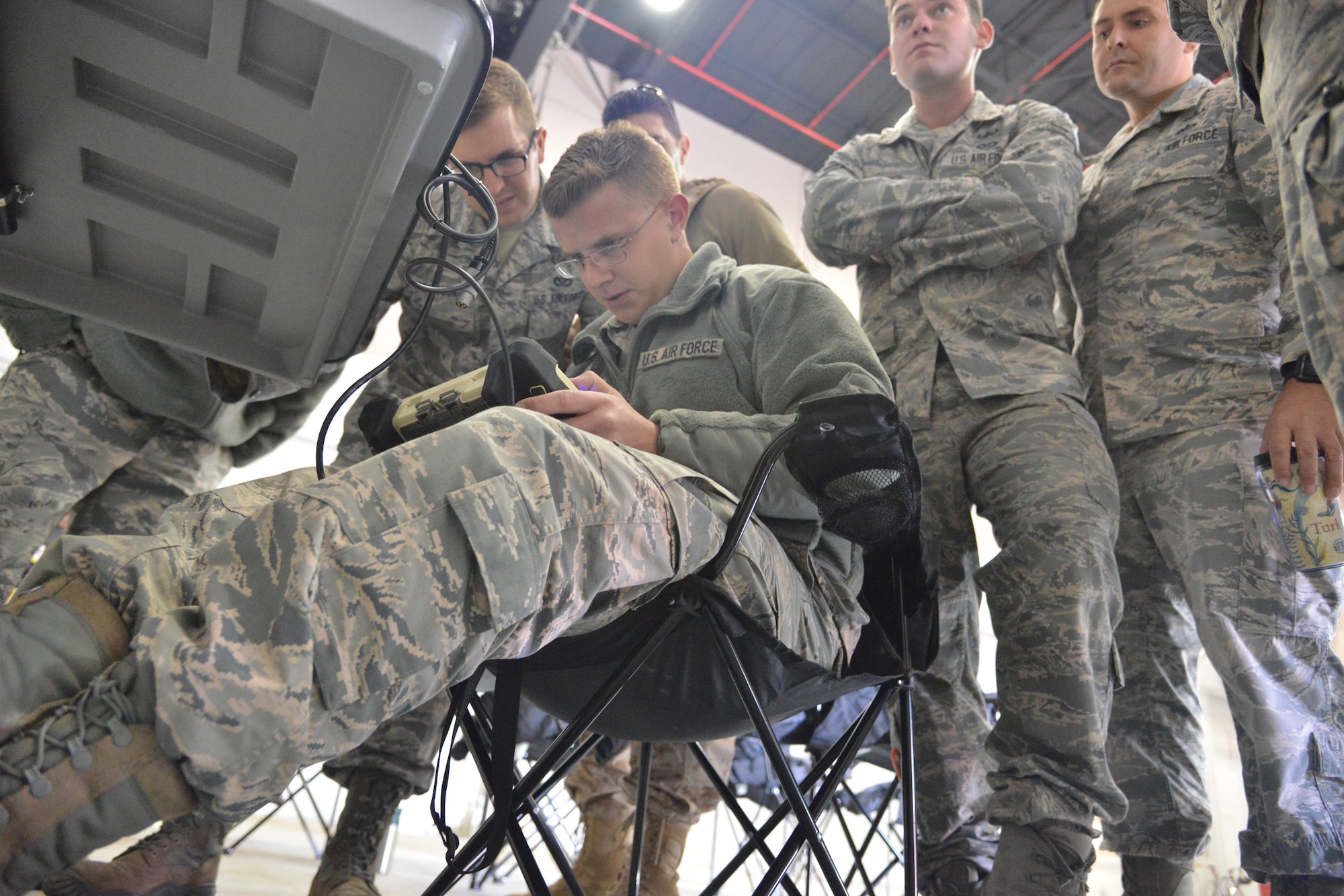 Members of Kirtland's 377th Explosive Ordnance Disposal maneuver a robot remotely during the Western National Rodeo and Capability Exercise. The event, hosted by Los Alamos and Sandia national laboratories, tested the EOD's robot handling skills against eight other teams. (Photo by Todd Berenger) 
