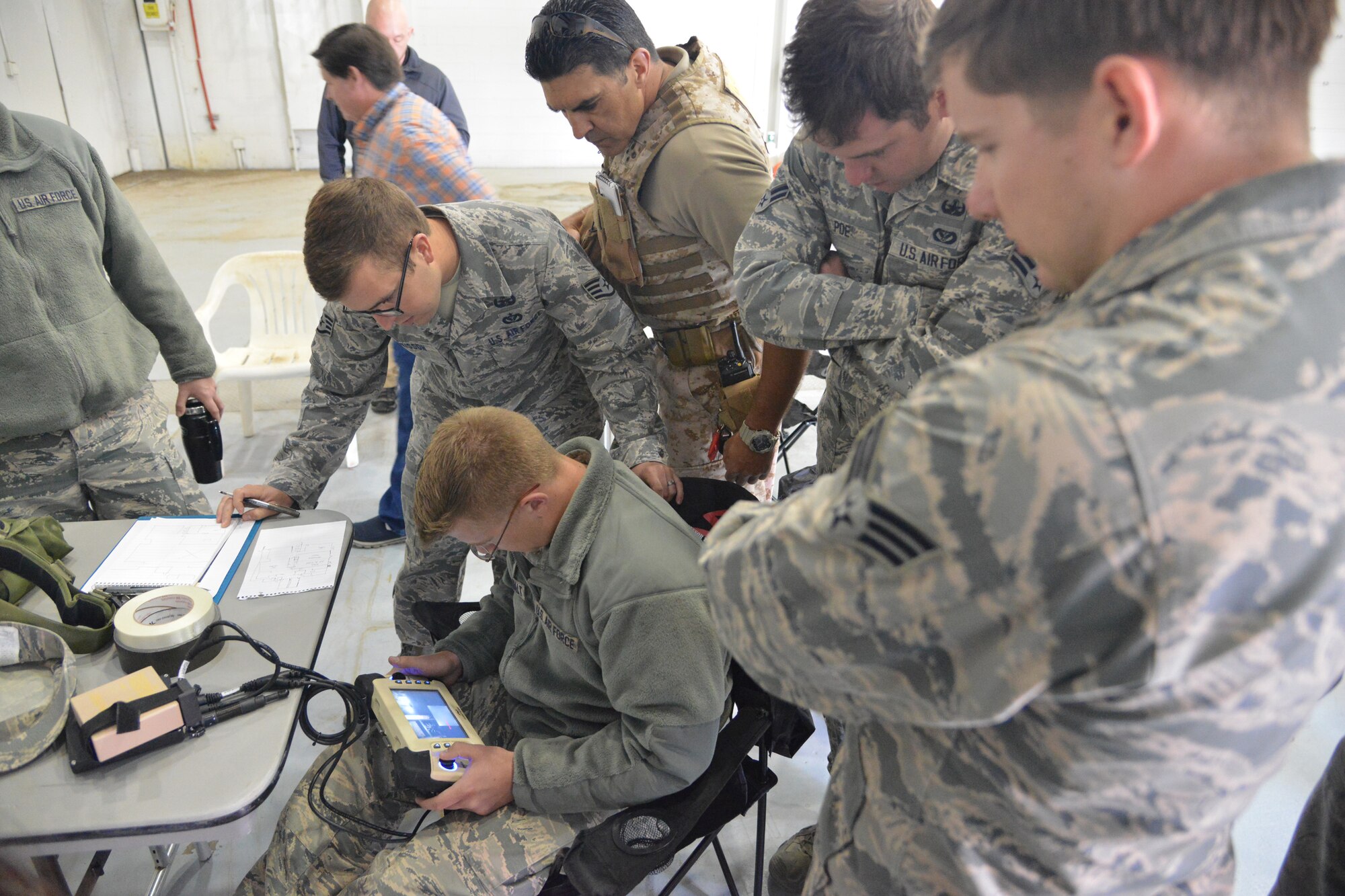 Members of Kirtland's 377th Explosive Ordnance Disposal maneuver a robot remotely during the Western National Rodeo and Capability Exercise. The event, hosted by Los Alamos and Sandia national laboratories, tested the EOD's robot handling skills against eight other teams. (Photo by Todd Berenger) 
