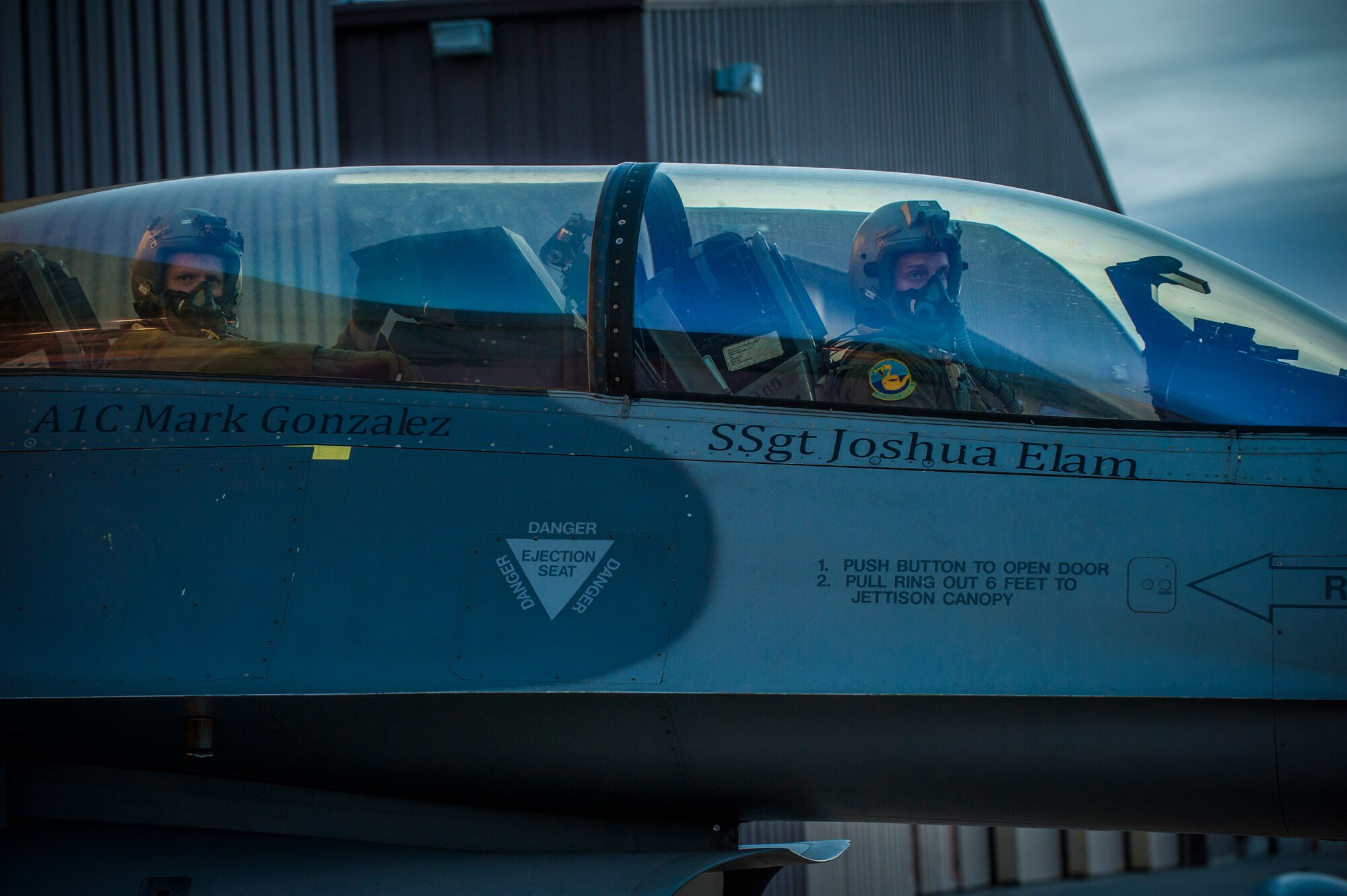 An F-16 Flying Falcon student and instructor pilot wait to taxi out on the runway at Holloman Air Force Base, N.M. May 13, 2015. F-16 students and instructor pilots, from the 311th Fighter Squadron, are currently performing night operations as part of their syllabus. The operations are going on until June 12, and are designed to familiarize students with night vision goggles and night combat missions. (U.S. Air Force photo by Airman 1st Class Emily A. Kenney/Released) 