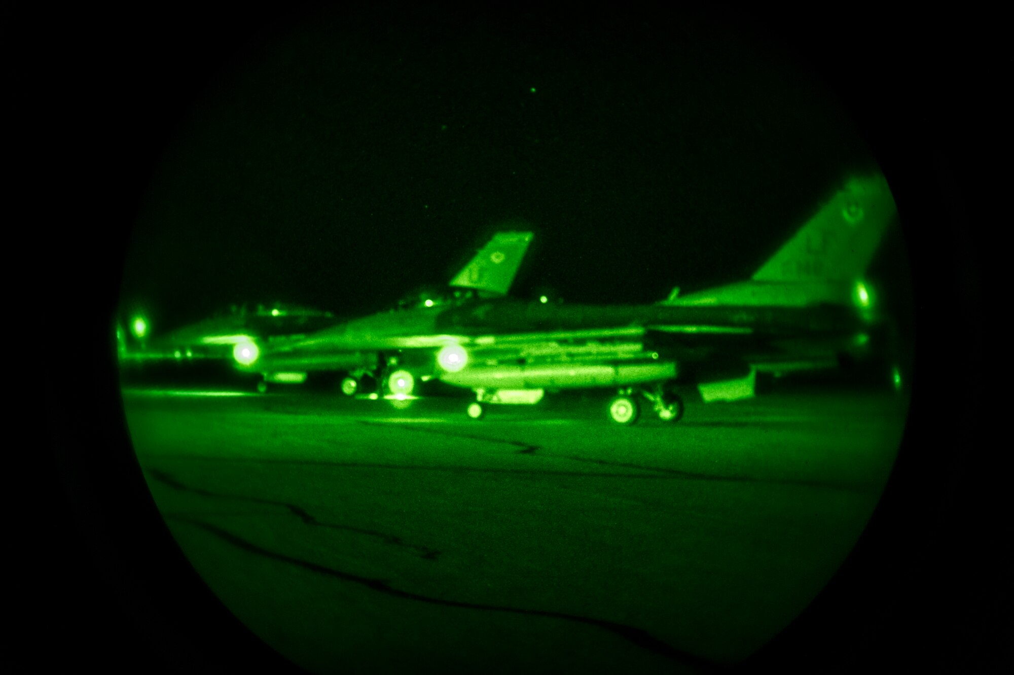F-16 Fighting Falcons wait on the runway prior to take off at Holloman Air Force Base, N.M. May 19, 2015. F-16 students from the 311th Fighter Squadron are at a point in their training where they are learning how to use night vision goggles and perform combat night operations.  (U.S. Air Force photo by Airman 1st Class Emily A. Kenney/Released)