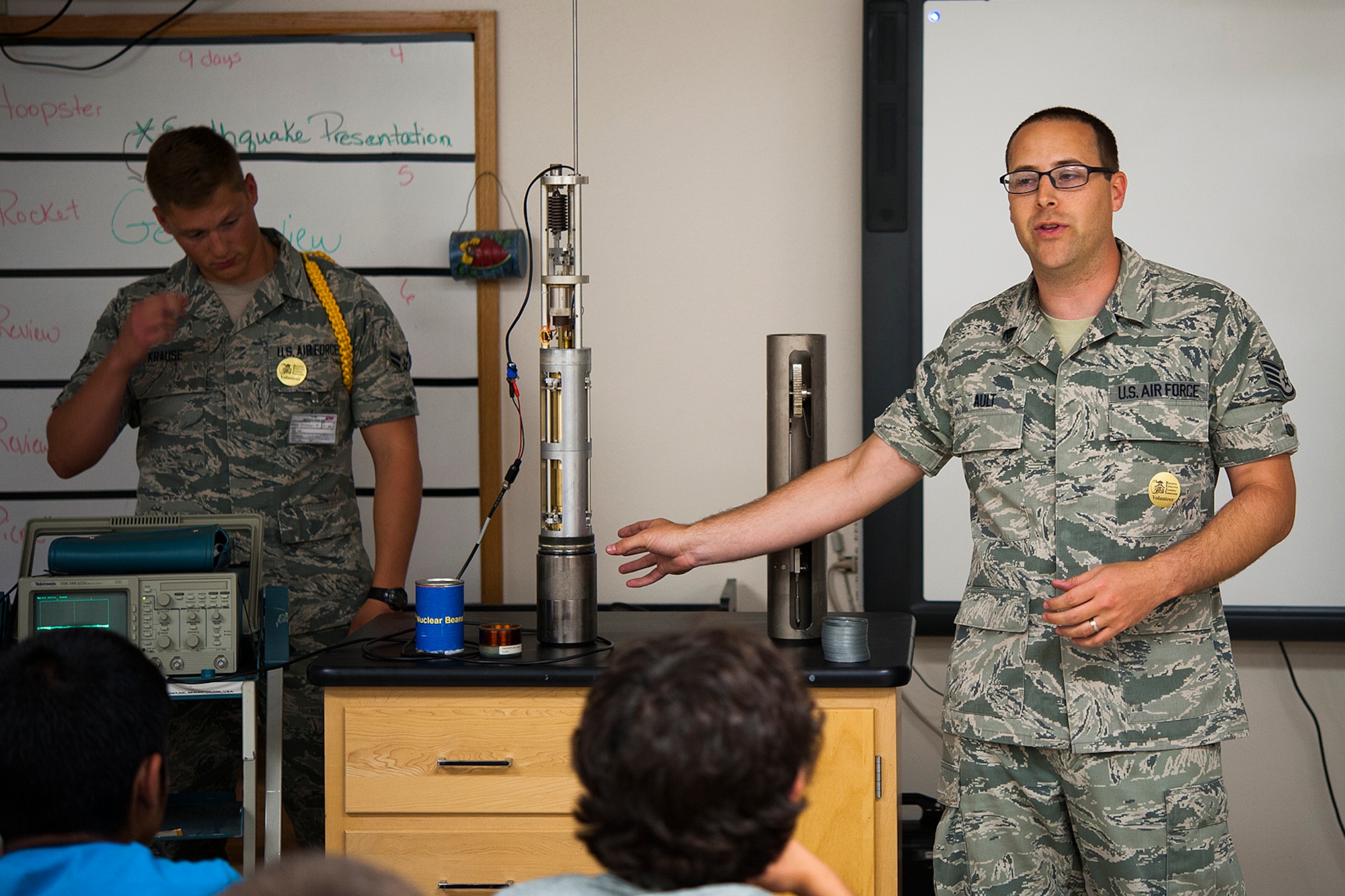 U.S. Air Force Staff Sgt. James D. Ault, 312th Training Squadron instructor, explains the use of a seismometer to 8th grade students at Lee Middle School in San Angelo, Texas, May 19, 2015. A seismometer is a device that measures motion of the ground to include seismic waves generated by earthquakes, volcanic eruptions and other seismic sources. (U.S. Air Force photo by Airman 1st Class Devin Boyer/Released)