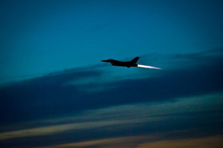 An F-16 Fighting Falcon takes off at Holloman Air Force Base, N.M. May 13, 2015. The 311th Fighter Squadron, a tenant unit from Luke Air Force Base, Ariz., trains F-16 pilots at Holloman. The students are currently at a point in their syllabus where they are learning how to use night vision goggles and perform combat night operations.  (U.S. Air Force photo by Airman 1st Class Emily A. Kenney/Released)
