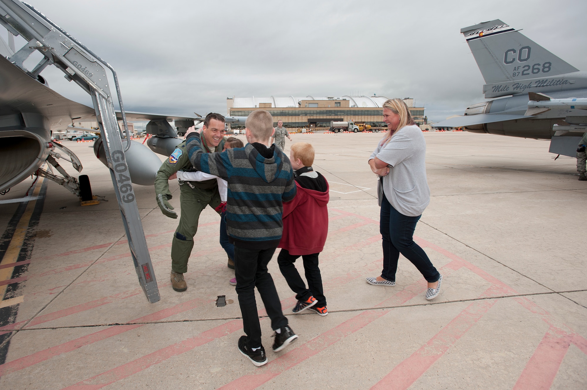 U.S. Air Force Lt. Col. Kurt Tongren???s family welcomes him home after landing an F-16 Fighting Falcon from the 120th Fighter Squadron, Colorado Air National Guard, at Buckley Air Force Base, Colo., upon his return from a deployment to the Republic of Korea, May 19, 2015. Integrating with other U.S. Air Force members, flying daily training mission and providing a Theater Security Package for the past 90 days, this return home marks the completion of the seventh deployment for the "Redeyes" of the 120th FS along with the 140th Wing since Sept. 11, 2001. (U.S. Air National Guard photo by: Tech. Sgt. Wolfram M. Stumpf/RELEASED)
