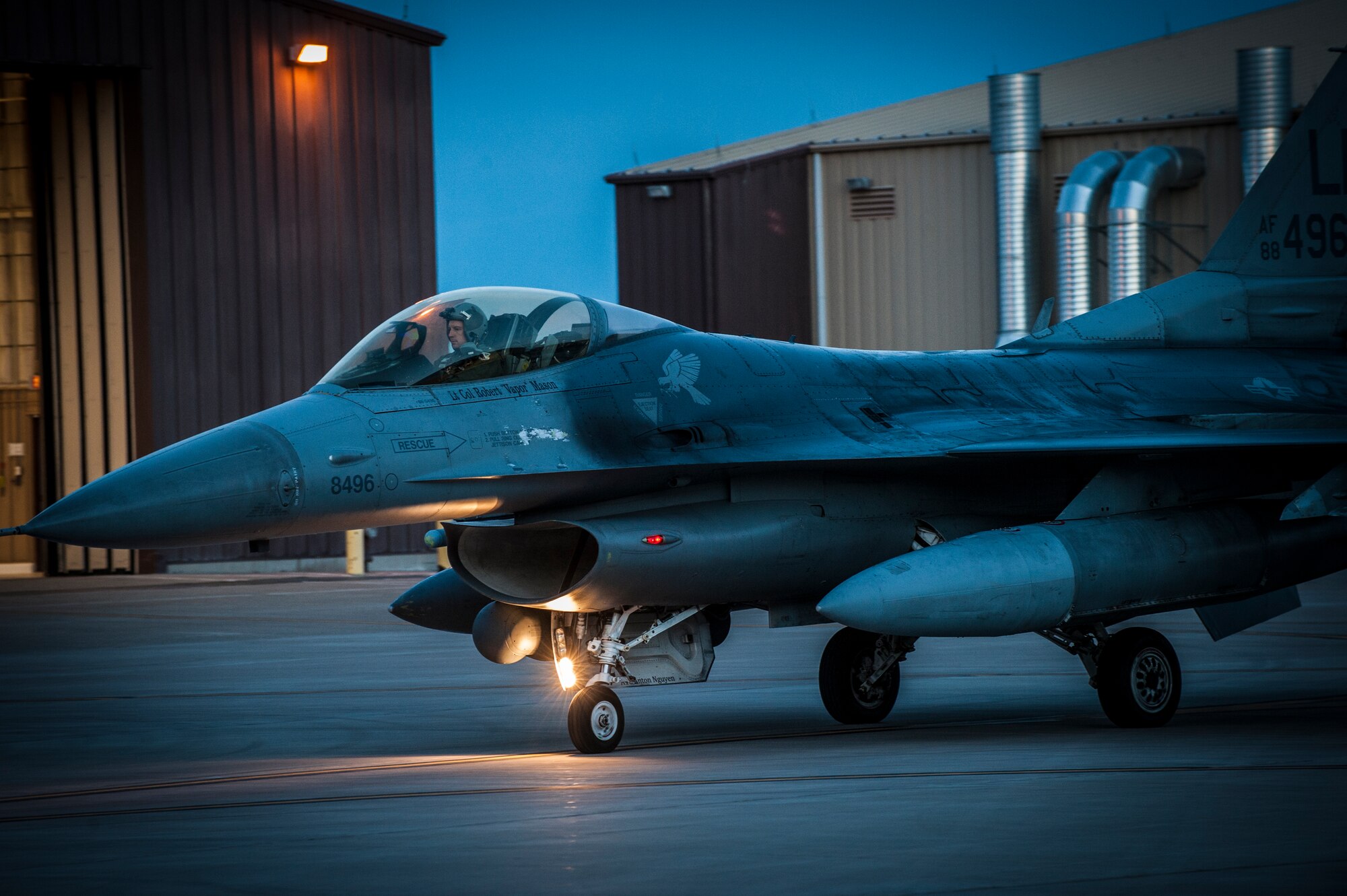 An F-16 Fighting Falcon taxis onto the runway at Holloman Air Force Base, N.M. May 13, 2015. F-16 students from the 311th Fighter Squadron, a tenant unit from Luke Air Force Base, Ariz., are performing night operations until June 12. The objective of the night operations is to familiarize pilots with night vision goggles and night combat operations. (U.S. Air Force photo by Airman 1st Class Emily A. Kenney/Released)  
