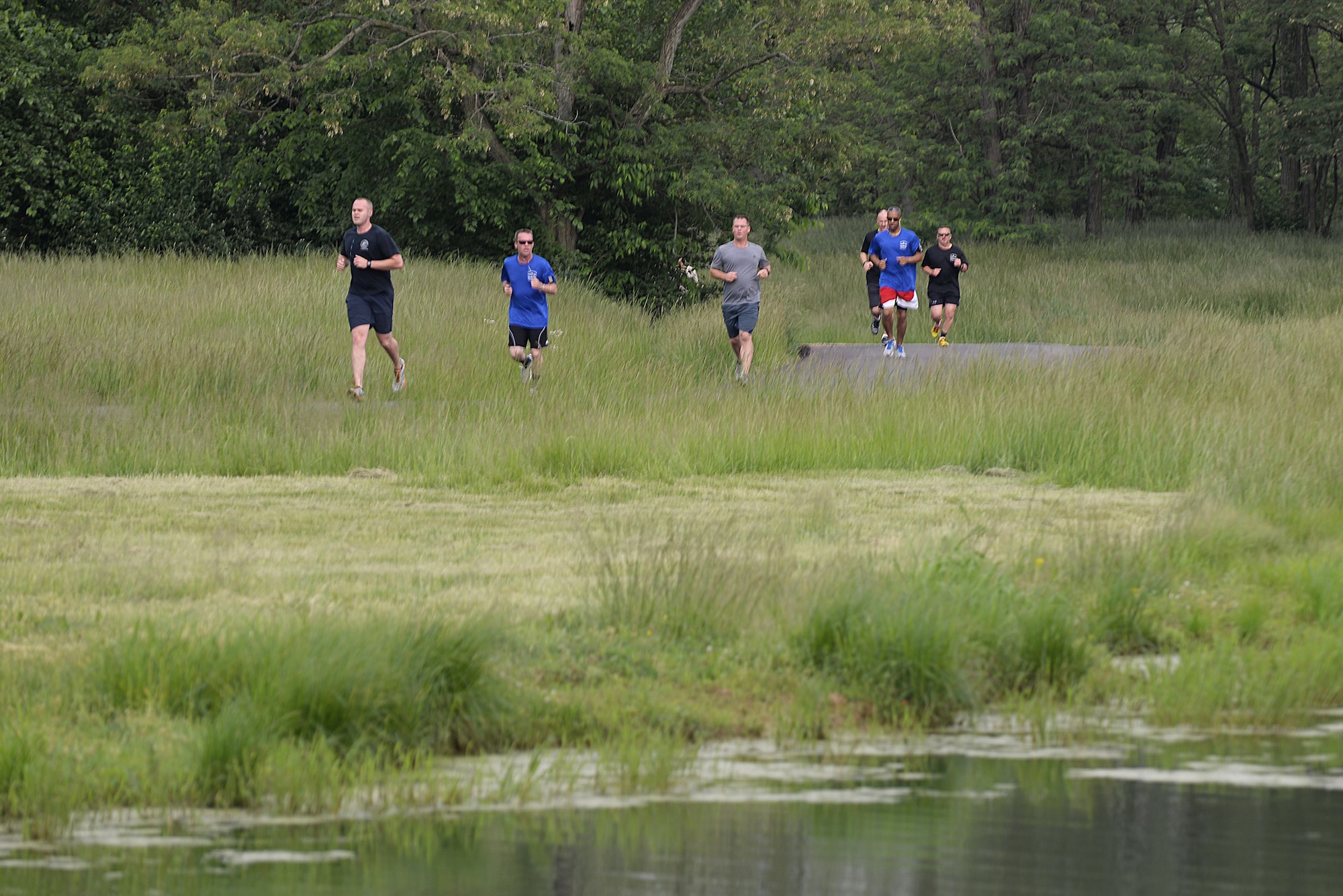 Team Scott members run a 5k around Scott Lake during the Port Dawg Annual Memorial Run at Scott Air Force Base, Illinois, May 15, 2015. The memorial run was one of the events held in honor of National Defense Transportation Week, which ran May 10 to 16 to show support the military and civilian personnel in the transportation industry. (U.S. Air Force photo/Senior Airman Joshua Eikren)