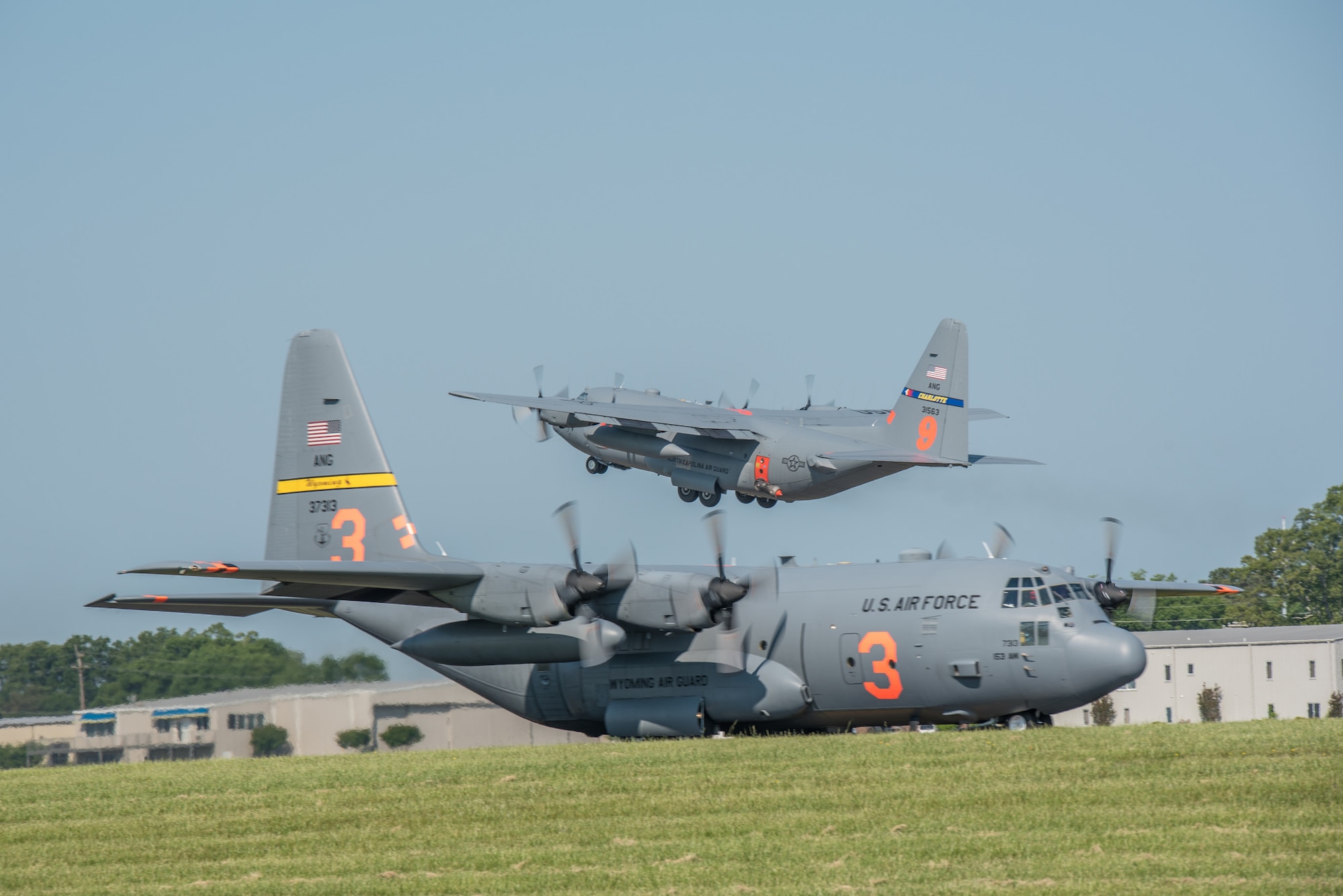 A Modular Airborne Fire Fighting System (MAFFS) equipped C-130H Hercules aircraft assigned to the 145th Airlift Wing, North Carolina Air National Guard takes off as a MAFFS equipped C-130H assigned to the 153rd Airlift Wing, Wyoming Air National Guard taxies May 5, 2015 at Donaldson Field in Greenville, South Carolina. Aircrews from the 153rd Airlift Wing and 145th Airlift Wing flew sorties over Angeles National Forest and executed water drops as part of their annual training and recertification. (U.S. Air National Guard photo by Master Sgt. Charles Delano)