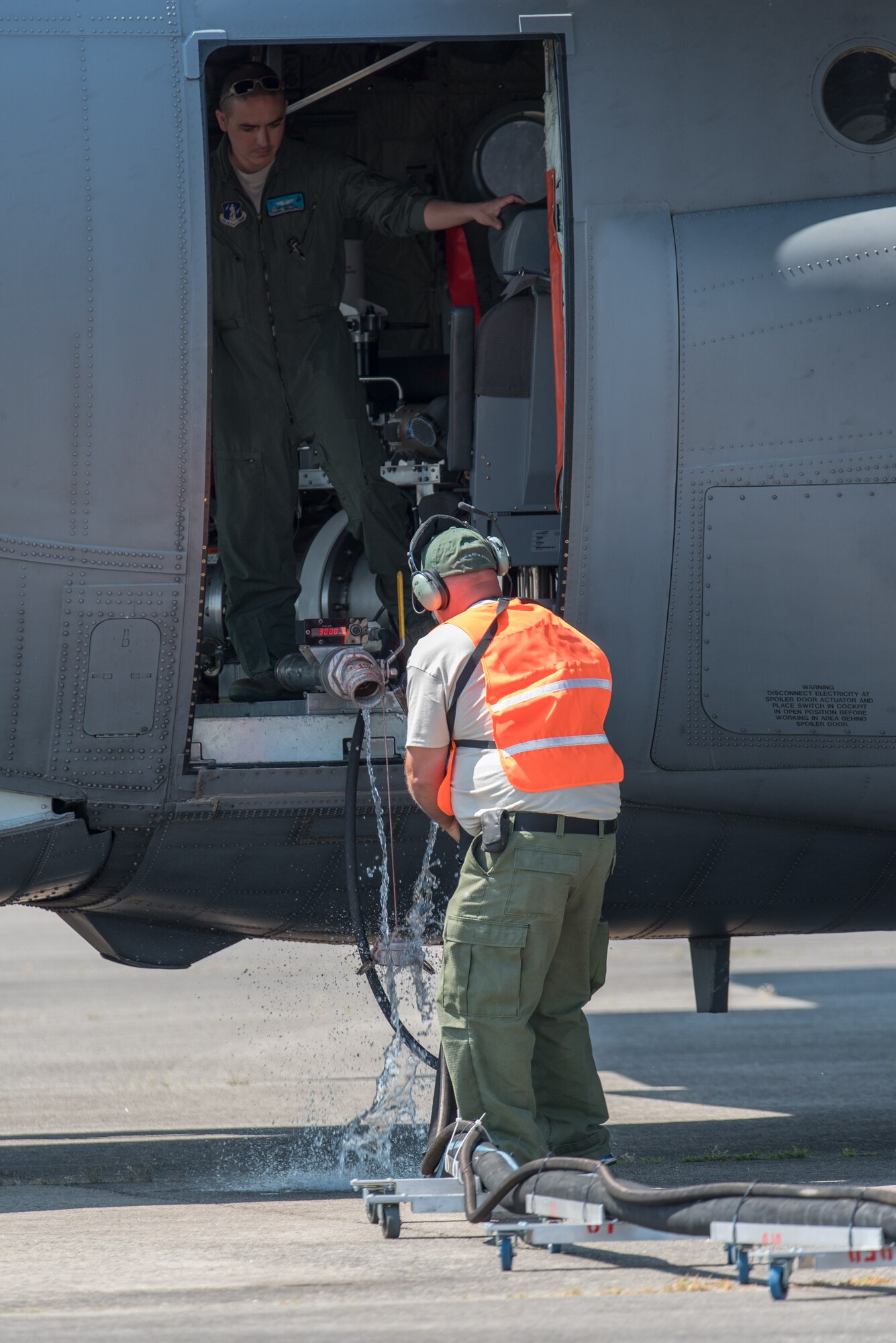 A U.S. Forest Service technician disengages a coupling after filling the tank on a Modular Airborne Fire Fighting System (MAFFS) equipped C-130H Hercules aircraft assigned to the 153rd Airlift Wing, Wyoming Air National Guard May 5, 2015 at Donaldson Field in Greenville, South Carolina. Aircrews from the 153rd Airlift Wing and 145th Airlift Wing flew sorties over Angeles National Forest and executed water drops as part of their annual training and recertification. (U.S. Air National Guard photo by Master Sgt. Charles Delano)