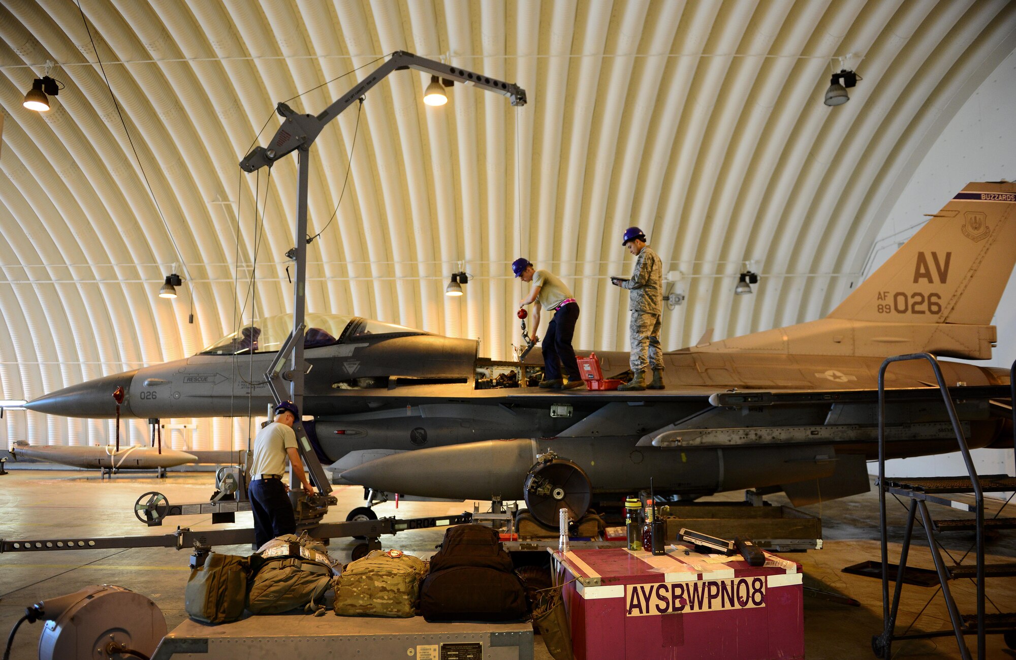 U.S. Air Force load crew members from the 31st Aircraft Maintenance Squadron install an M61A2 gun into an F-16 Fighting Falcon, May 20, 2015, at Aviano Air Base, Italy. Armament Airmen from the 31st Munitions Squadron and 31st AMXS are responsible for loading weapons onto aircraft, performing function checks and repairing munitions parts. (U.S. Air Force photo by Senior Airman Matthew Lotz/Released)