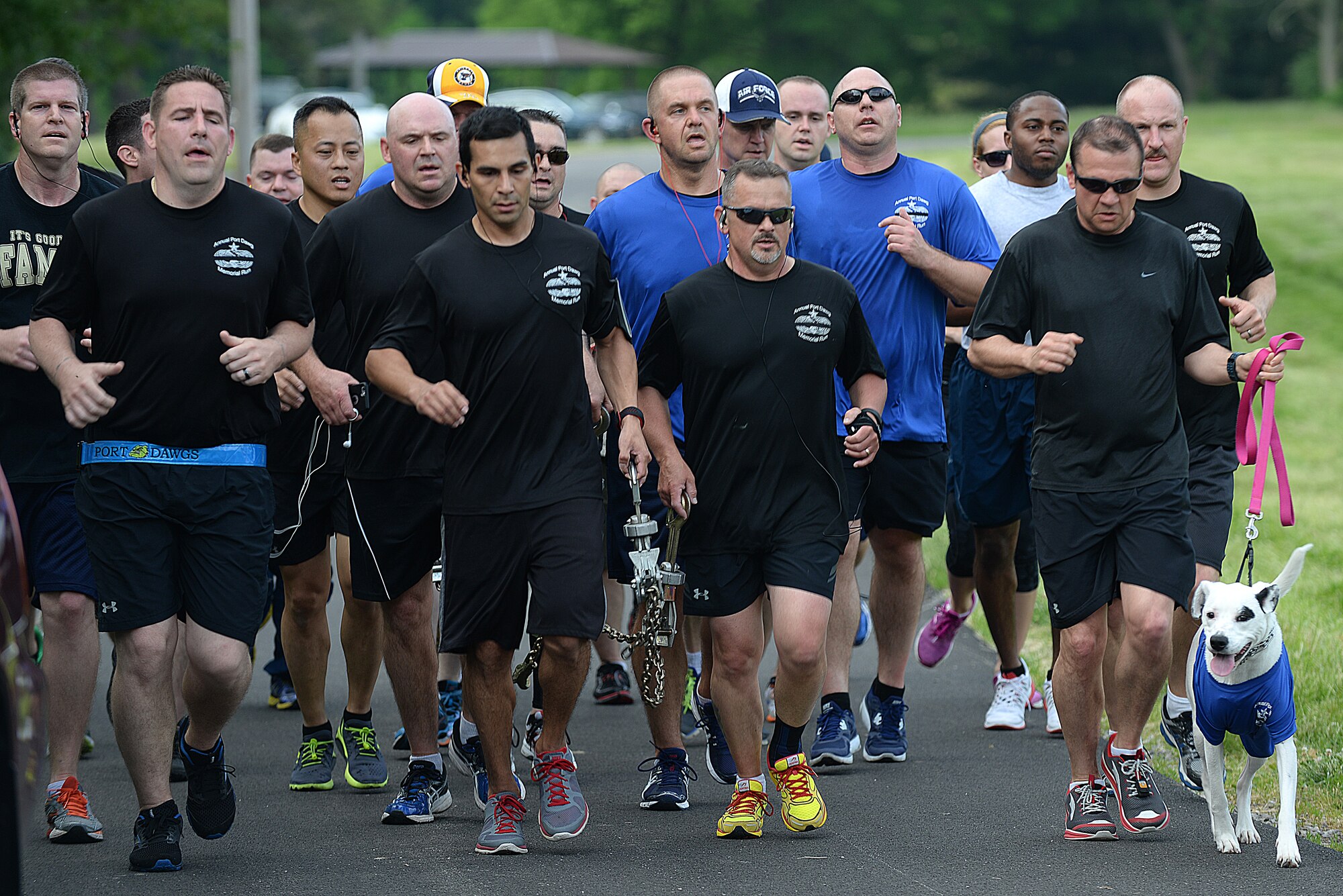 Team Scott members carry a chain during the Port Dawgs Memorial Run 5k around Scott Lake May 15, 2015 at Scott Air Force Base, Illinois. The run was held in honor of fallen Aerial Transporters or “Port Dawgs” and each device on the chain represented a fallen member they were remembering. (U.S. Air Force photo/Senior Airman Joshua Eikren)